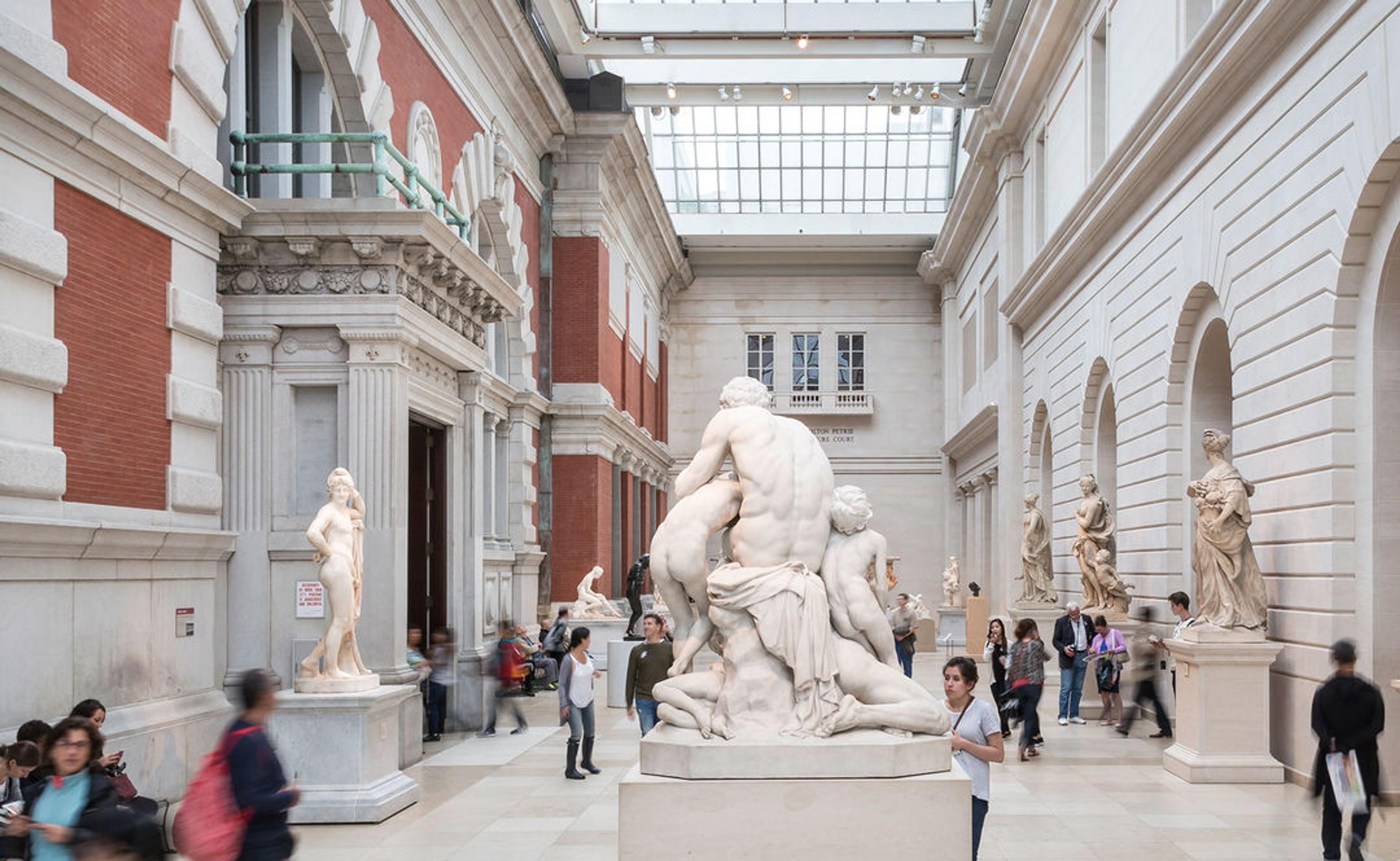 The Met's European Sculpture and Decorative Arts gallery filled with visitors.