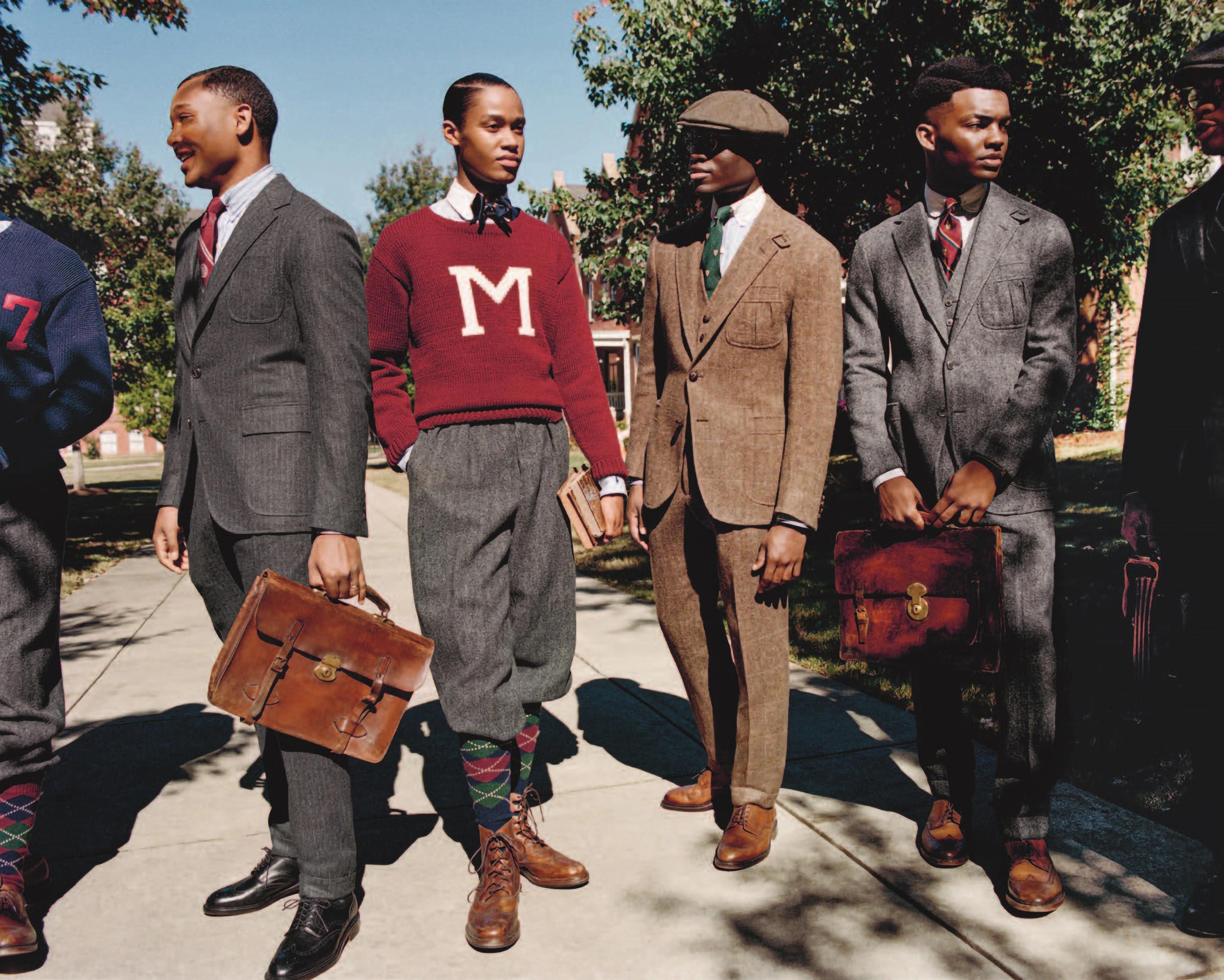Photo of four sharply dressed men posed on a sidewalk