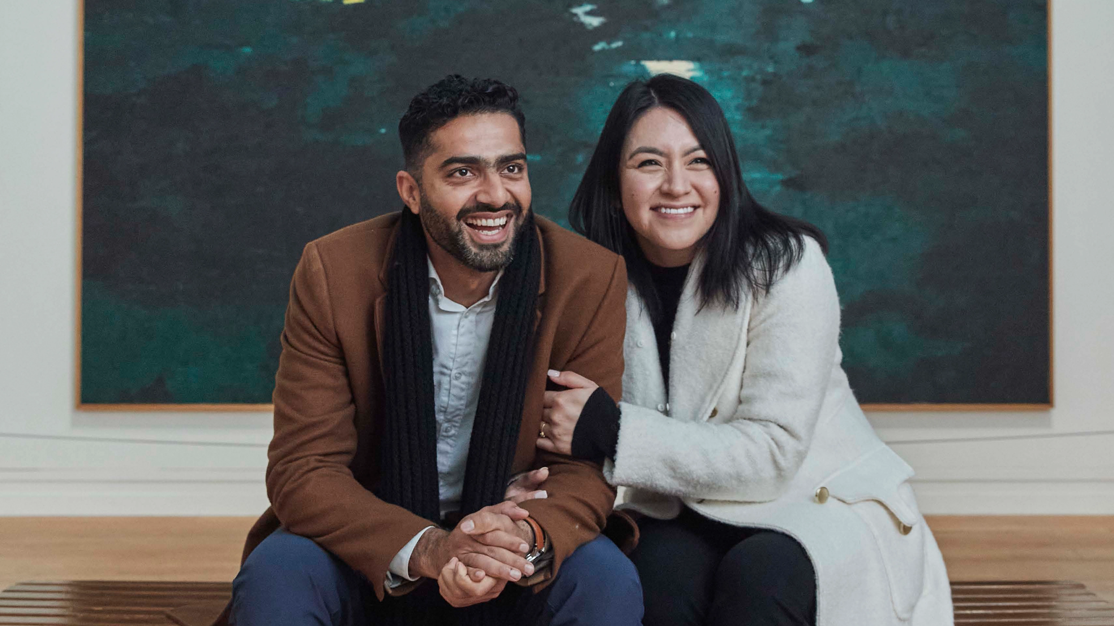 A couple sitting and smiling in The Met's Modern and Contemporary Galleries.