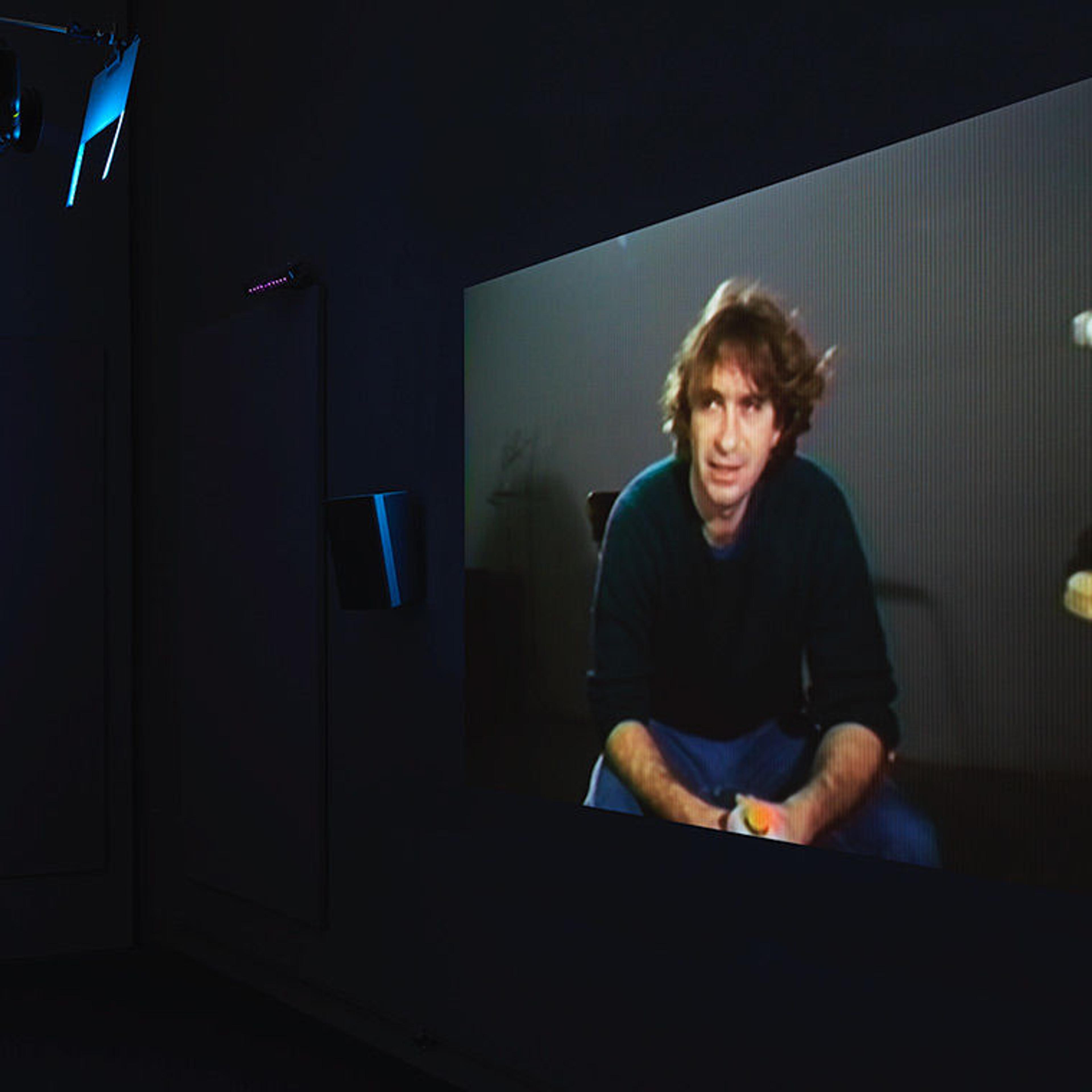Video projected on a screen in the William Wegman exhibition Before/On/After