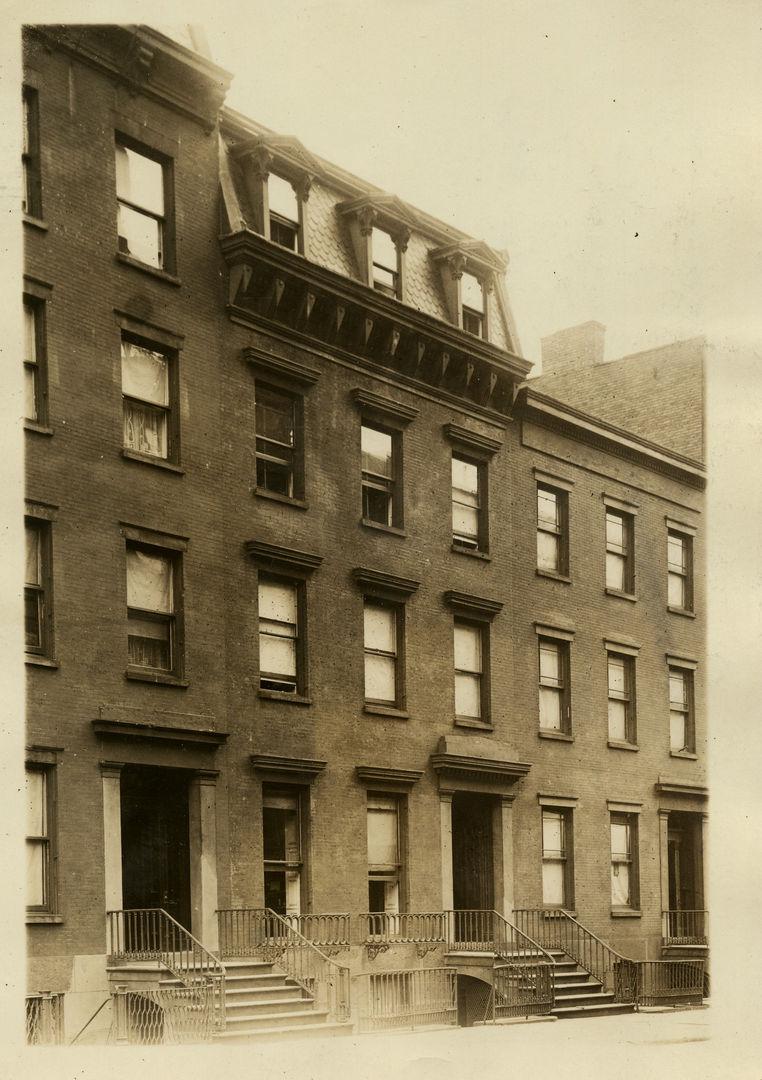 The buildings that field owned before they were torn down in a sepia photograph.