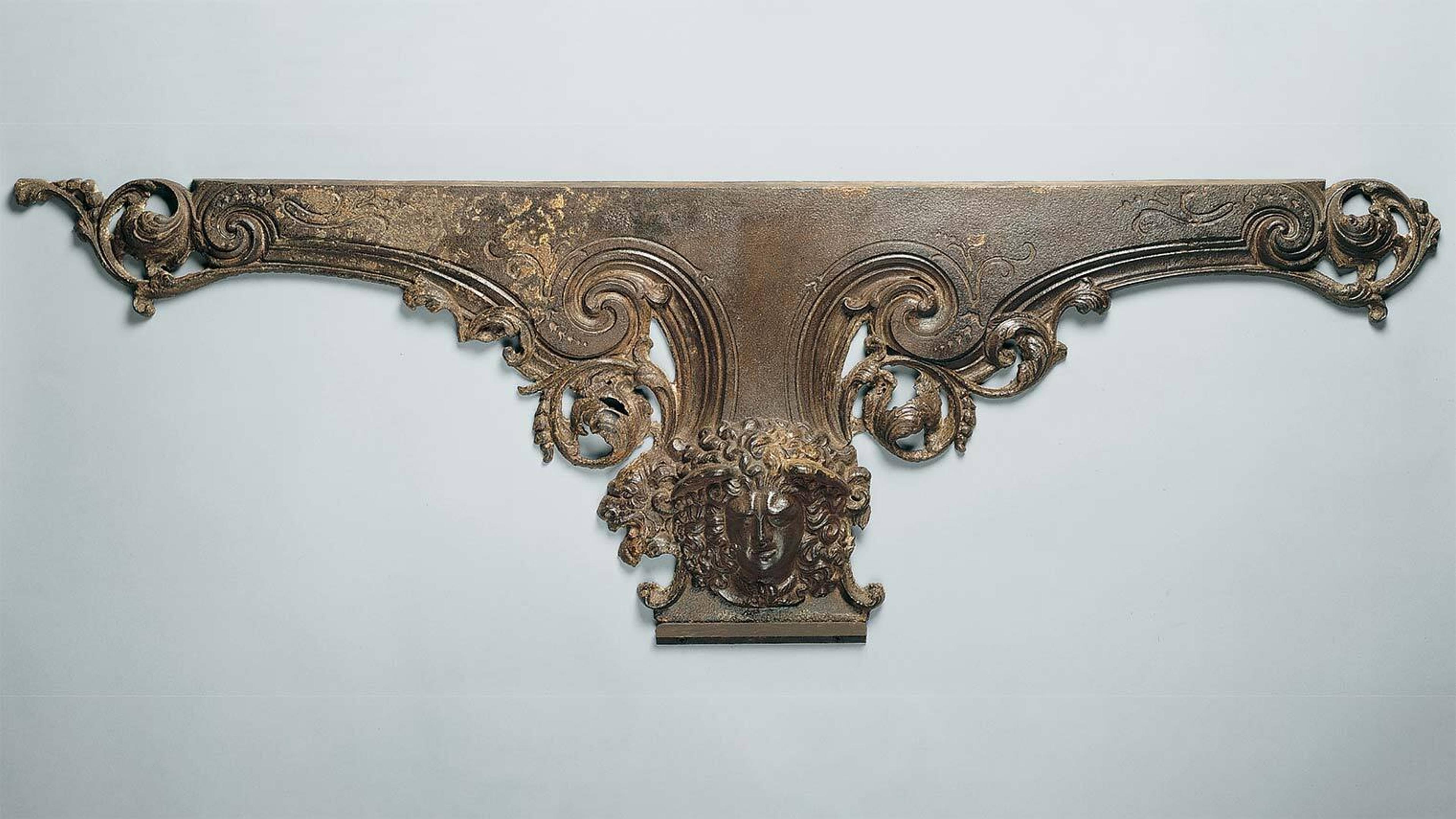 An ornate metal plinth