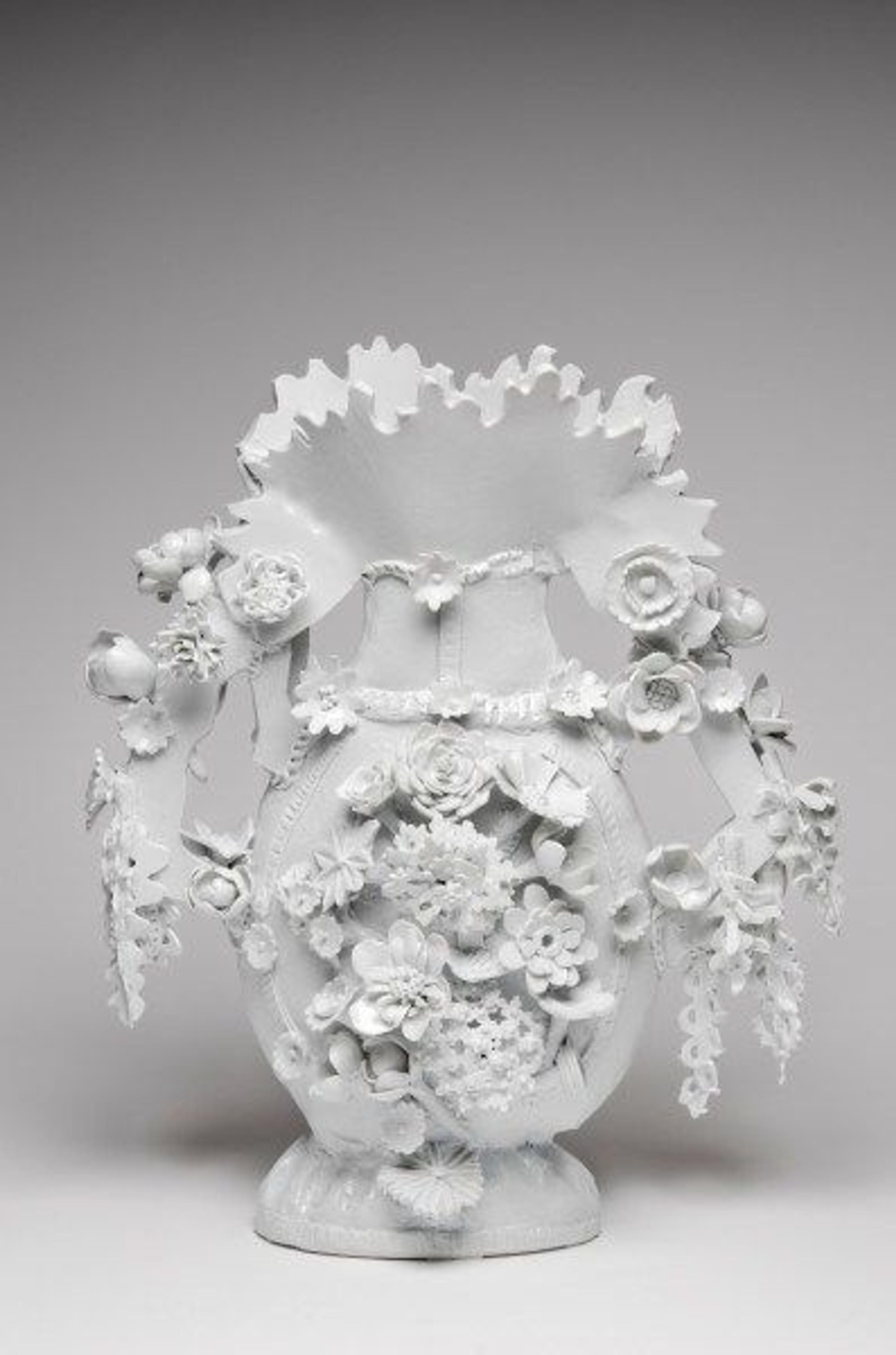 An ornate white porcelain vase created by Ann Agee