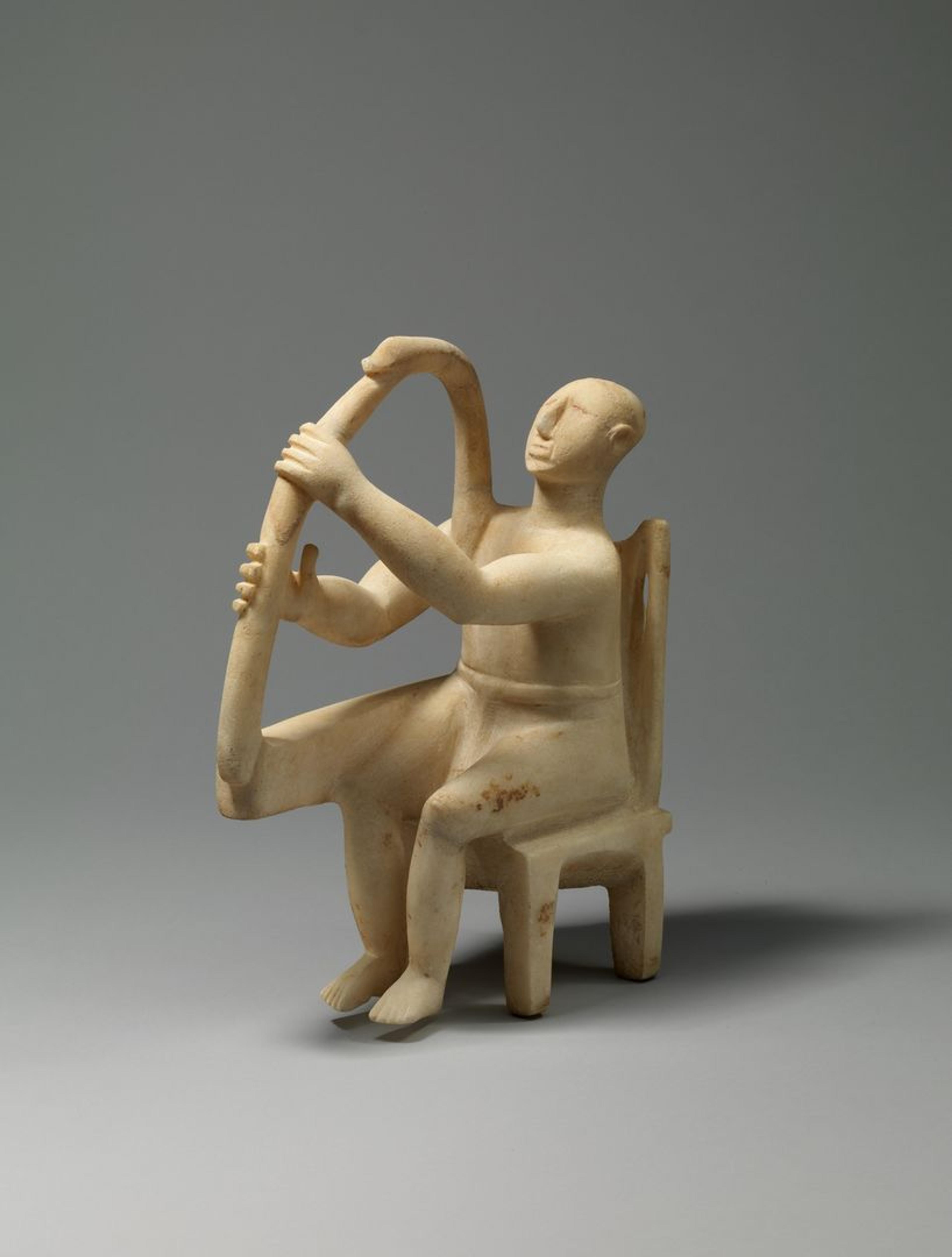 Cycladic stone statue of a harper seated.
