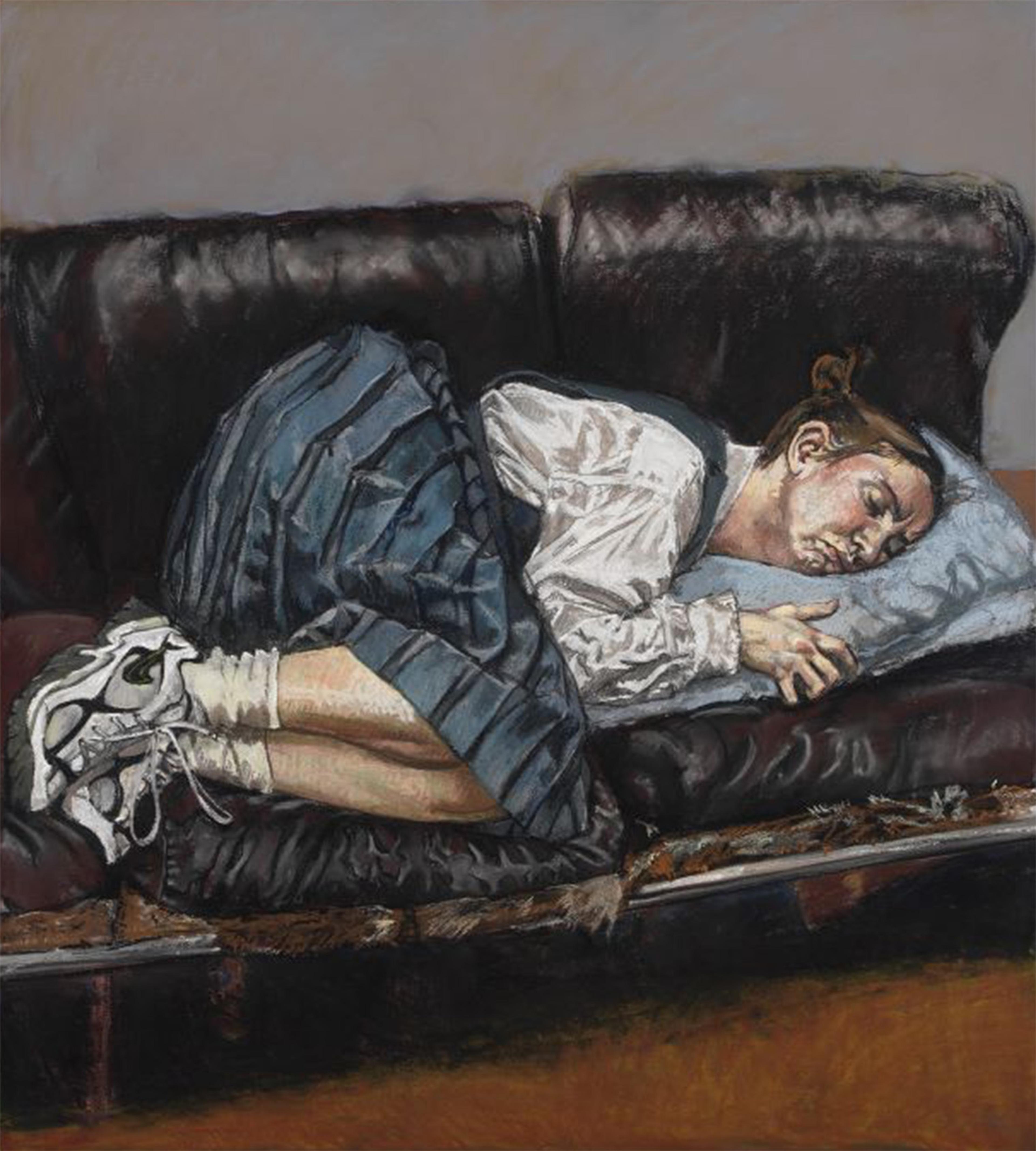 Woman in school dress and sneakers resting on couch.