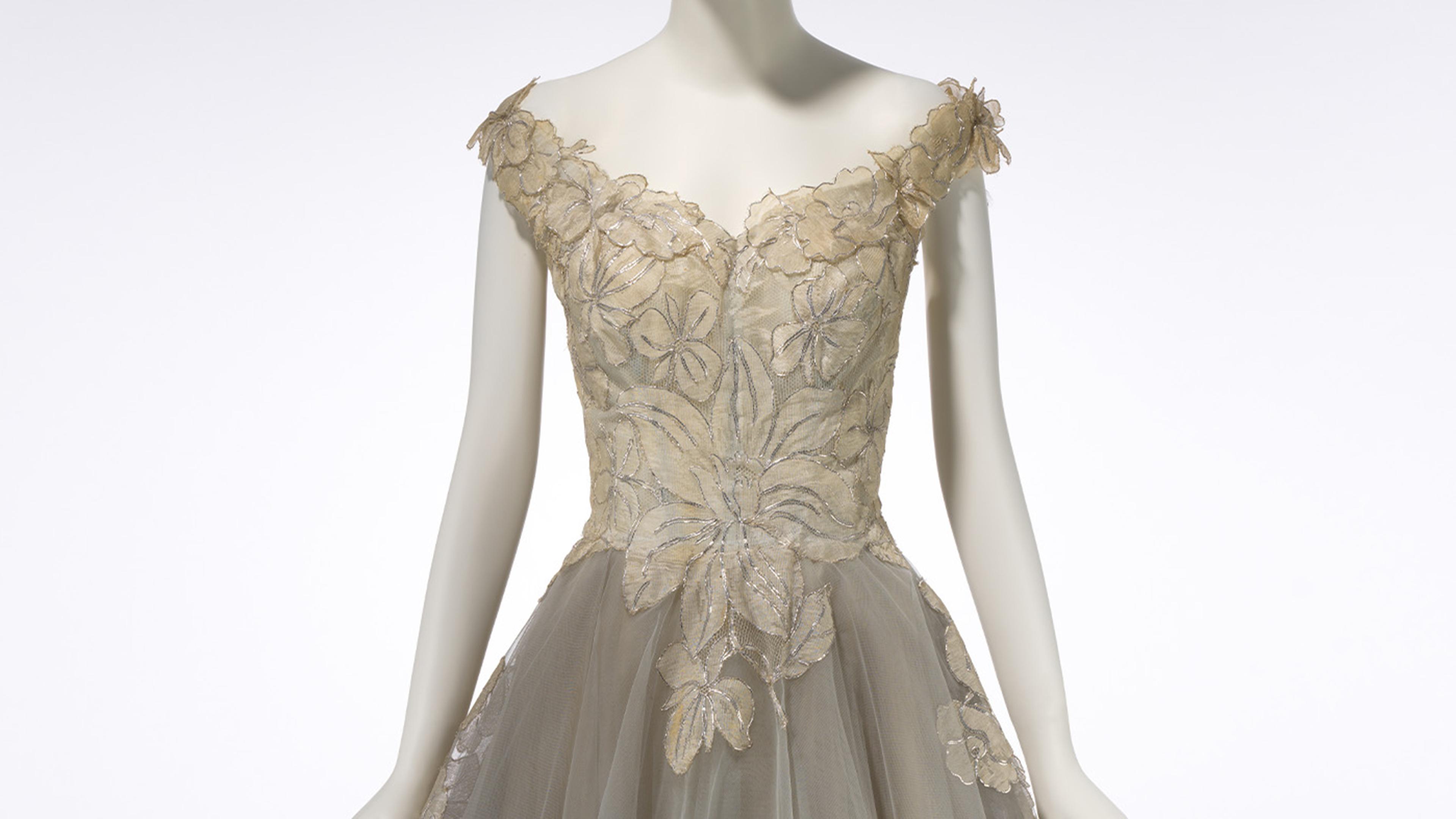 Mannequin displayed wearing lace designer dress.