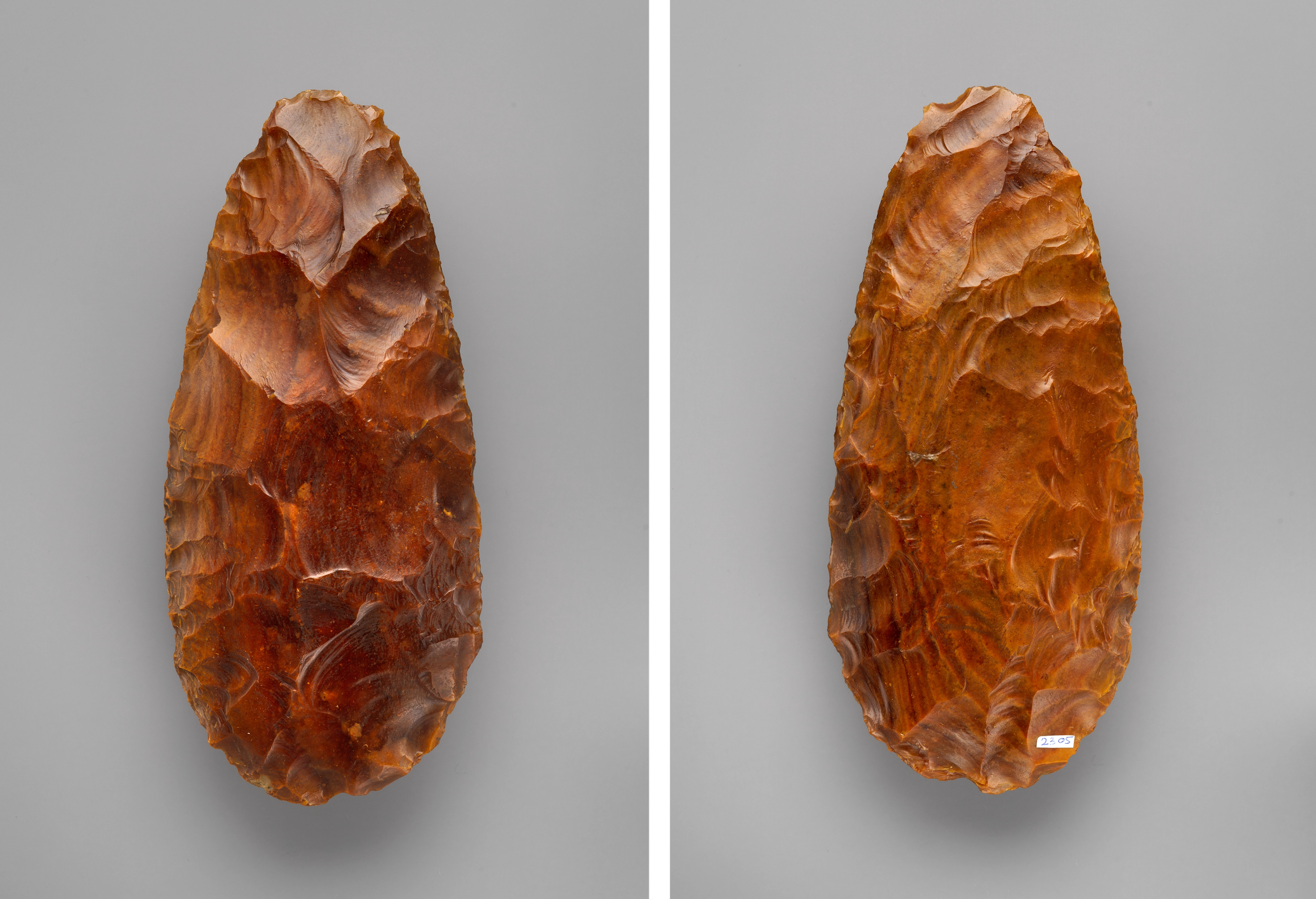 Two sides of a brown stone biface, shining almost like a polished wood.