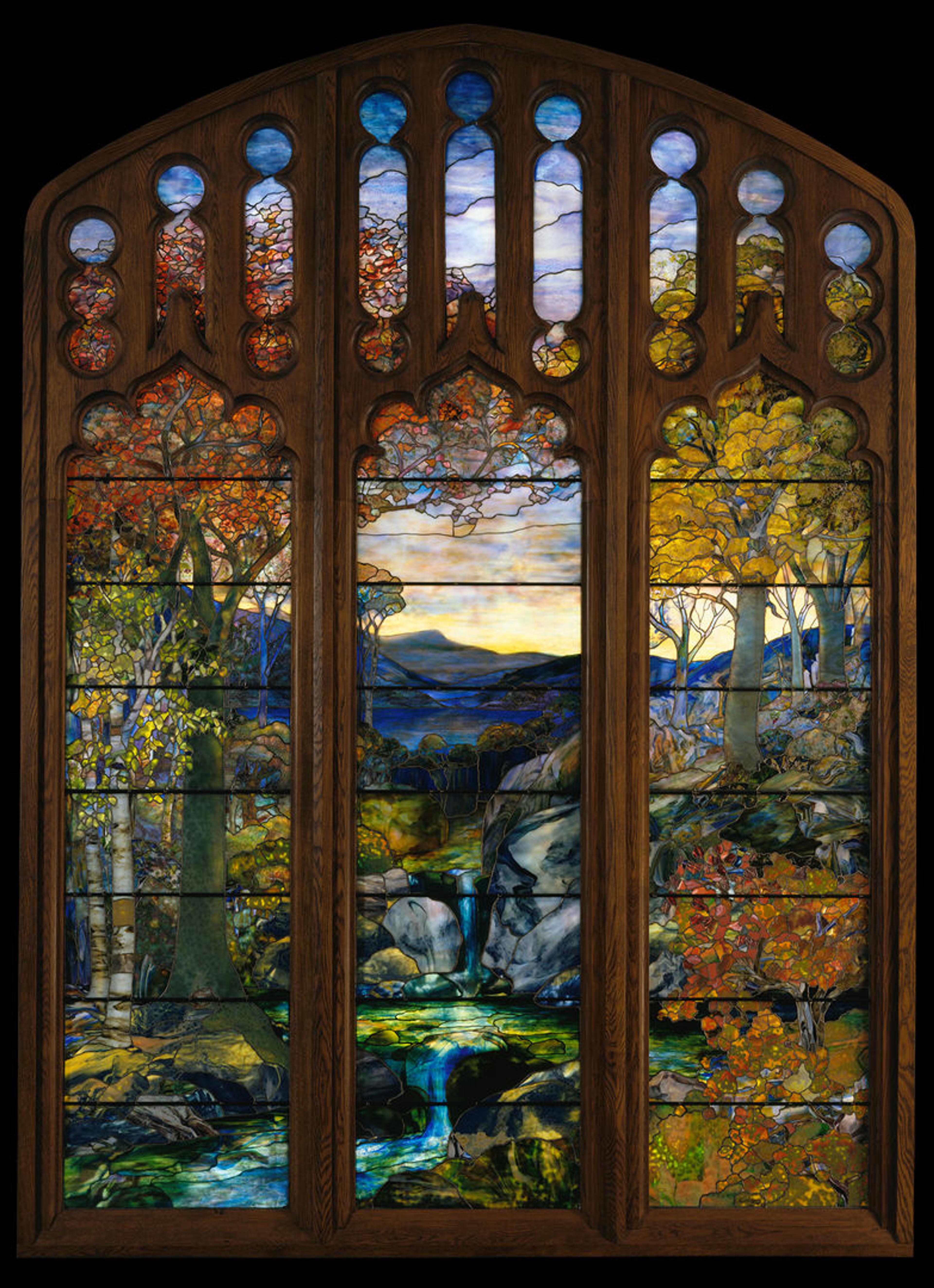 Autumn landscape featuring a river, mountains and trees made of stained glass