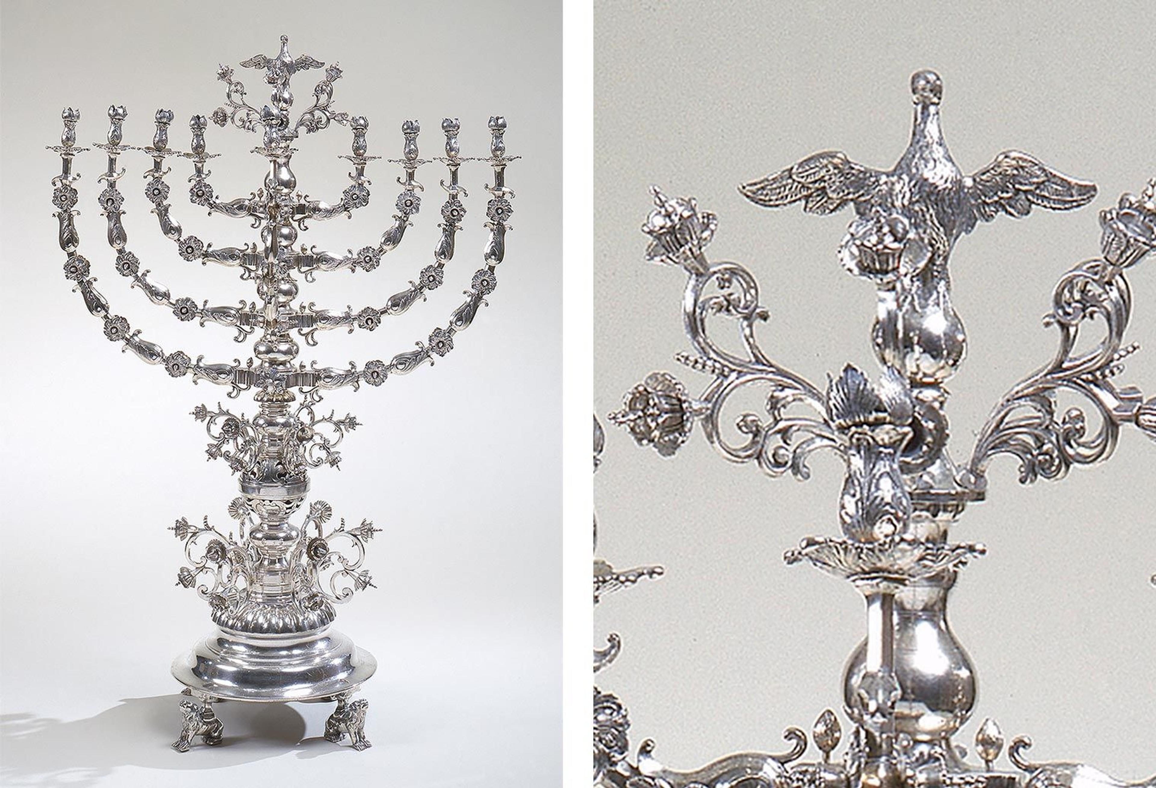 An ornate silver menorah with flowers, birds, and lions