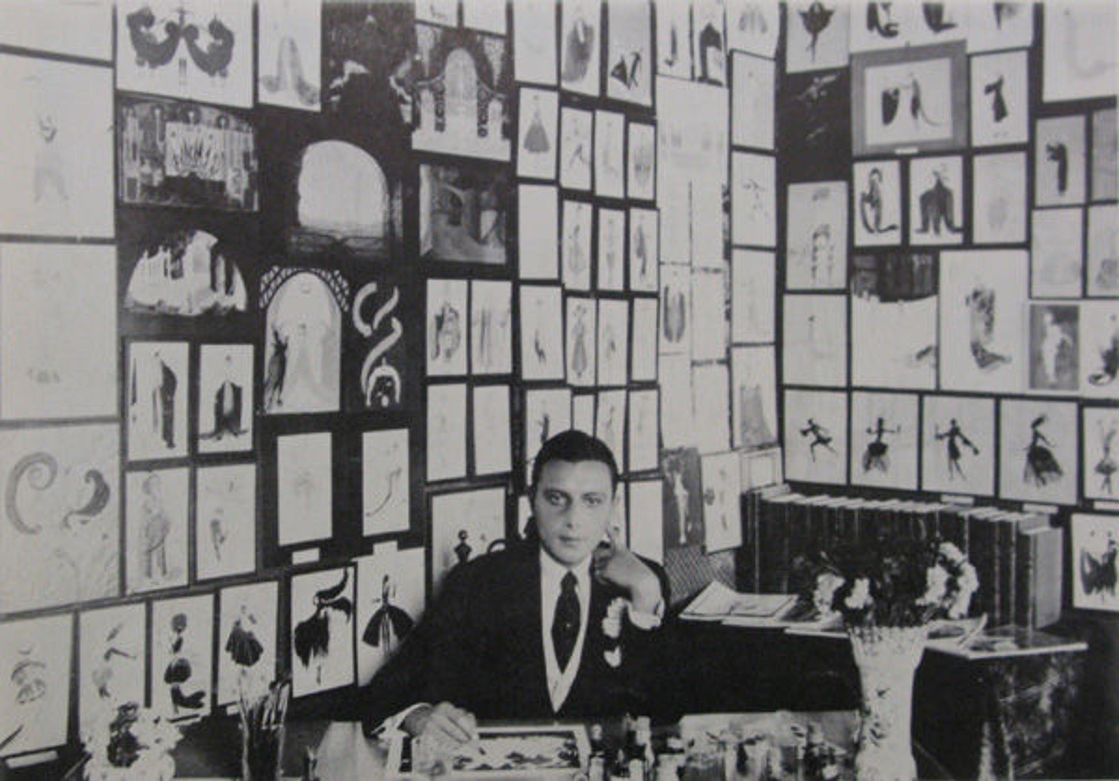 Fig. 5. Erté in his studio in Monte Carlo, the walls of which were covered in his drawings, 1917. Reproduction of a black and white photograph used in the pamphlet for his exhibition at the Grosvenor Gallery, New York, held June 7–July 1, 1967 