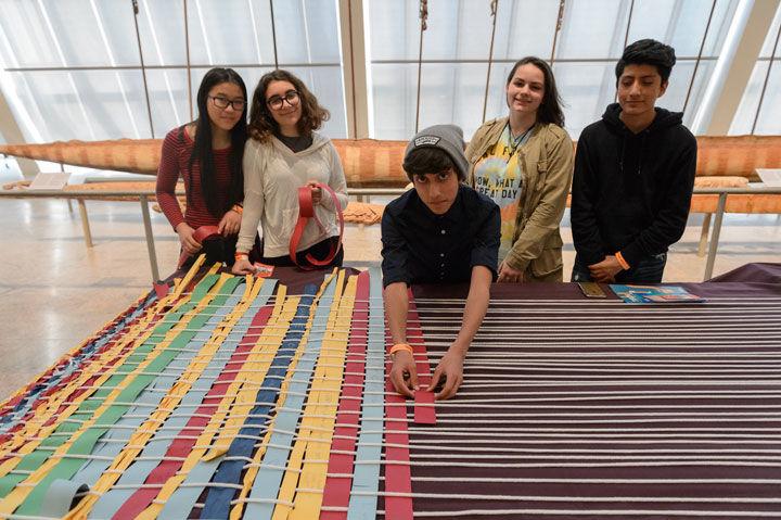Teens weave on the Mega Loom during the Teens Take The Met event