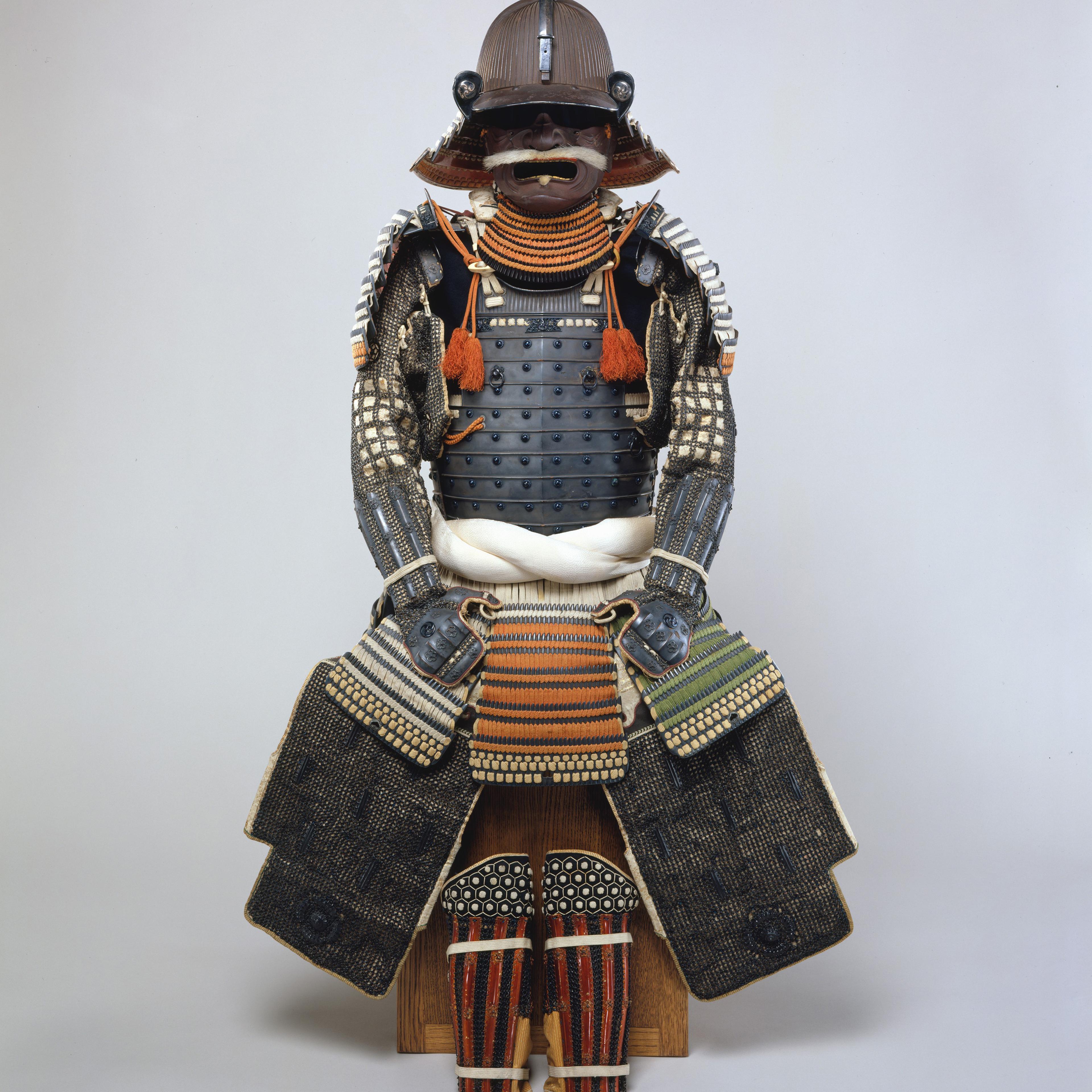 Image of Japanese armor. It features a kusazuri (skirt) with an extremely rare color scheme of silk lacings in red, yellowish-green, black, and white. The mon (heraldic badge), in the form of three whirling commas (mitsudomoe mon).