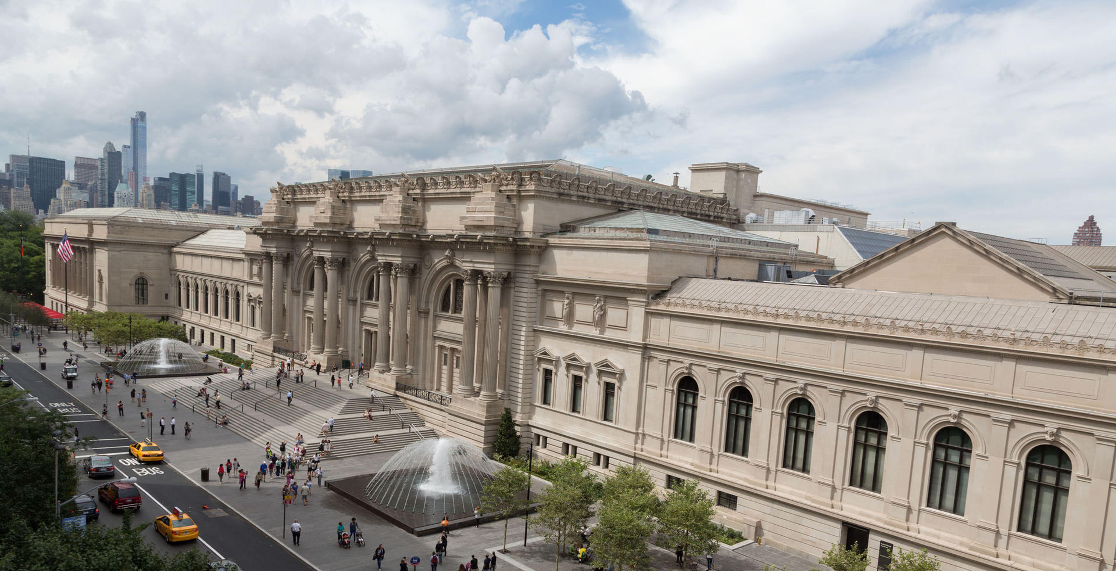 Photograph of The Metropolitan Museum of Art facade against a cloudy sky.