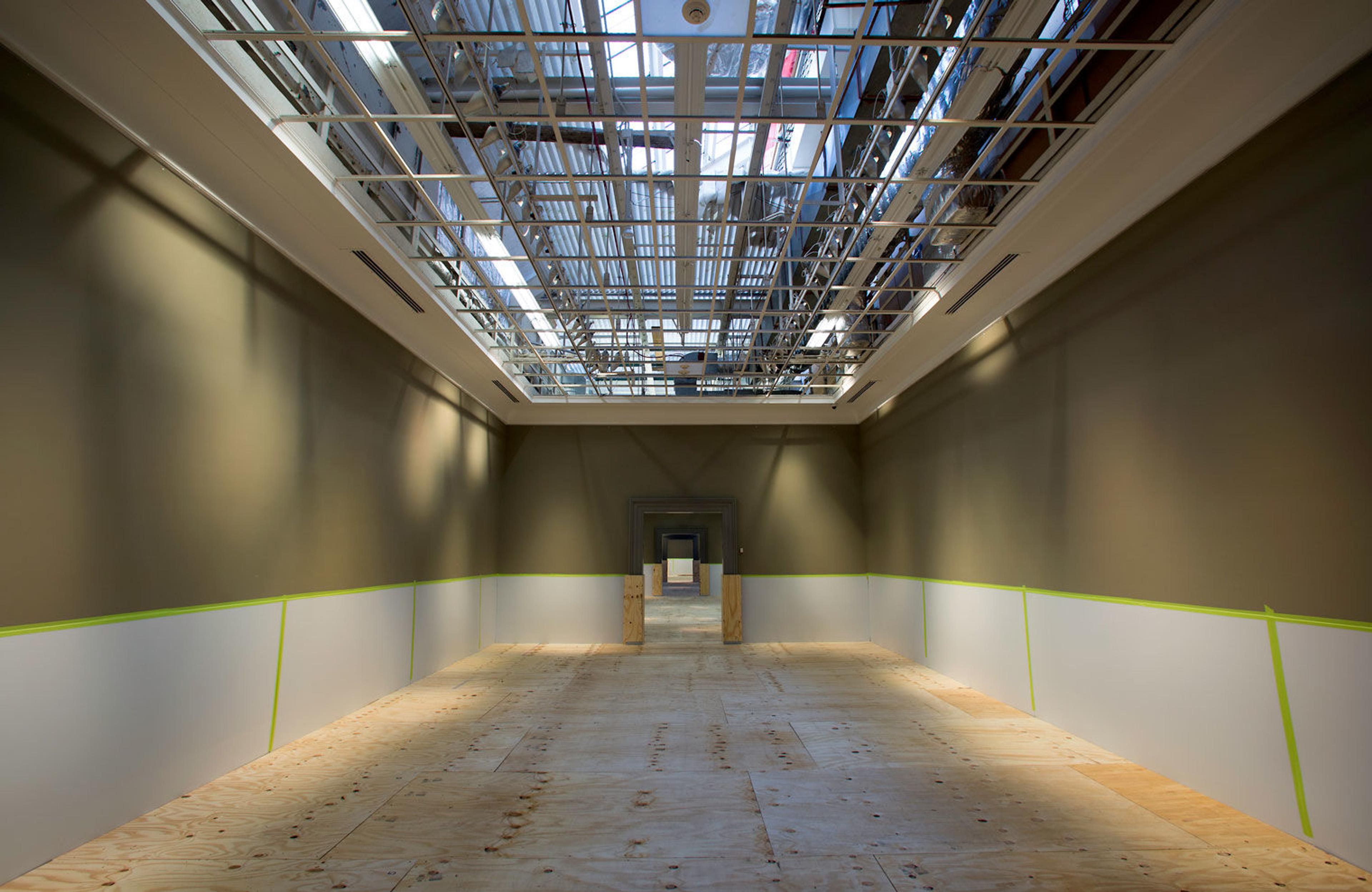 View of an empty gallery in The Met with exposed skylights in the ceiling