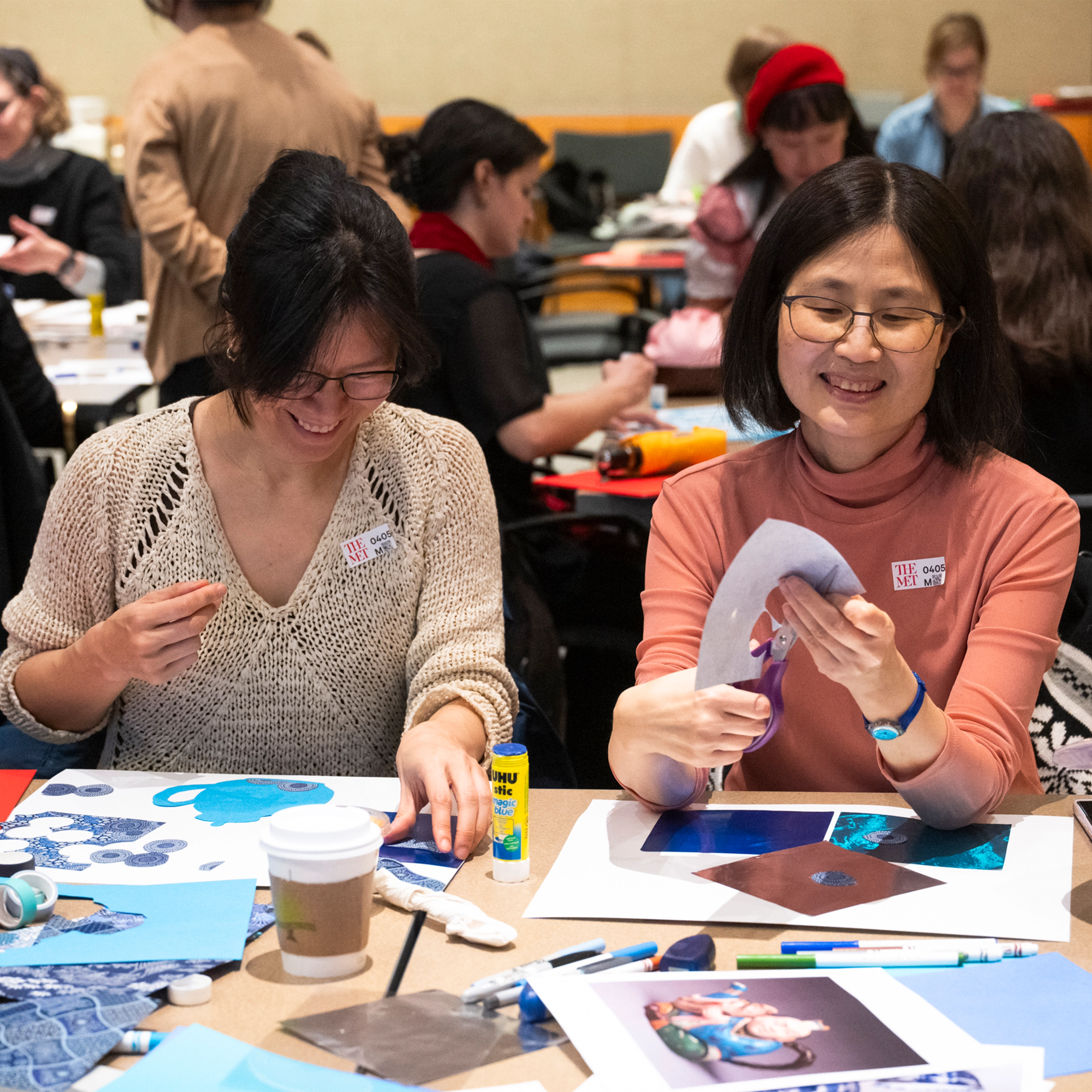 Two women participate in an art making activity.