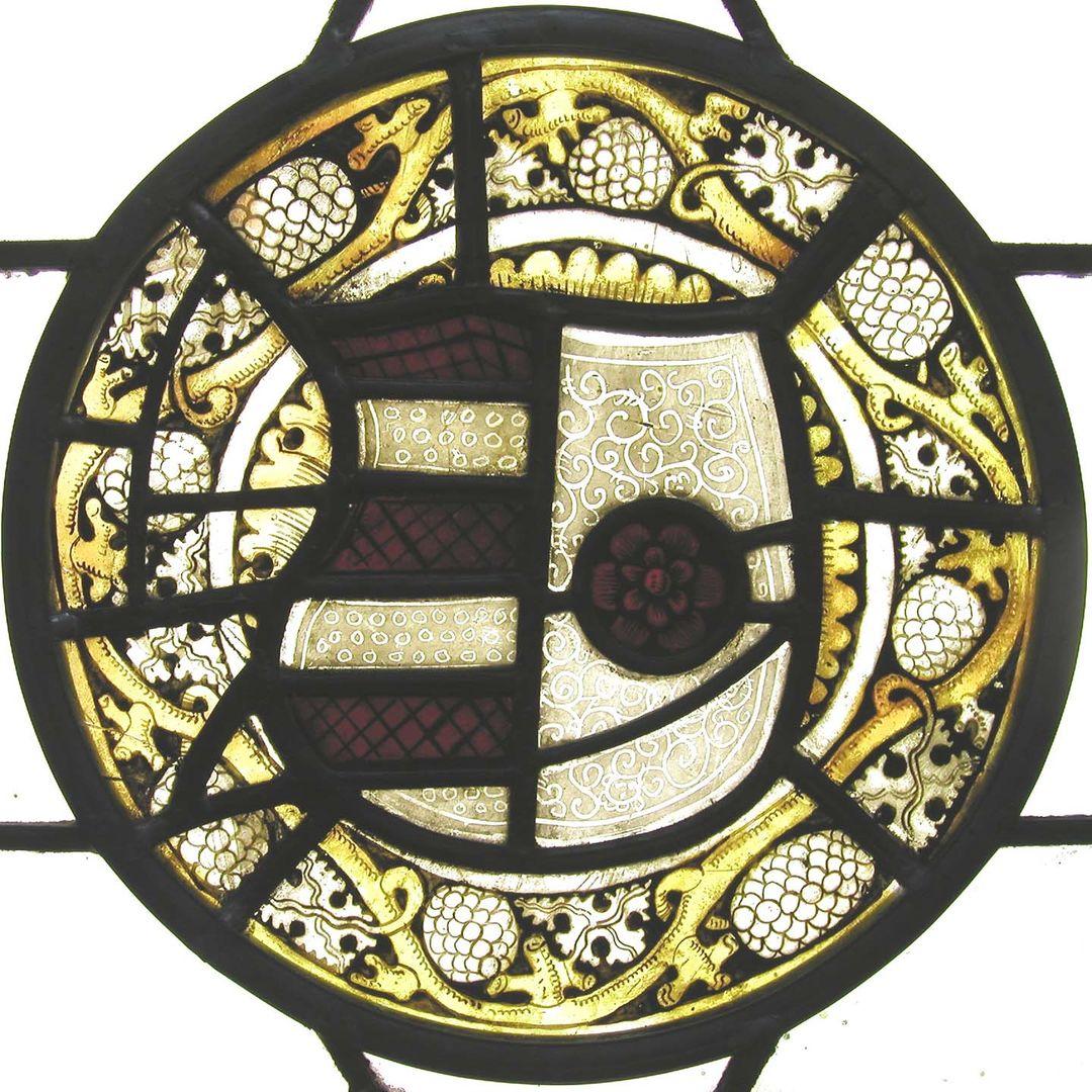 An armorial roundel depicting the arms of Barry of six Gules and Argent impaling Argent a Rose Gules