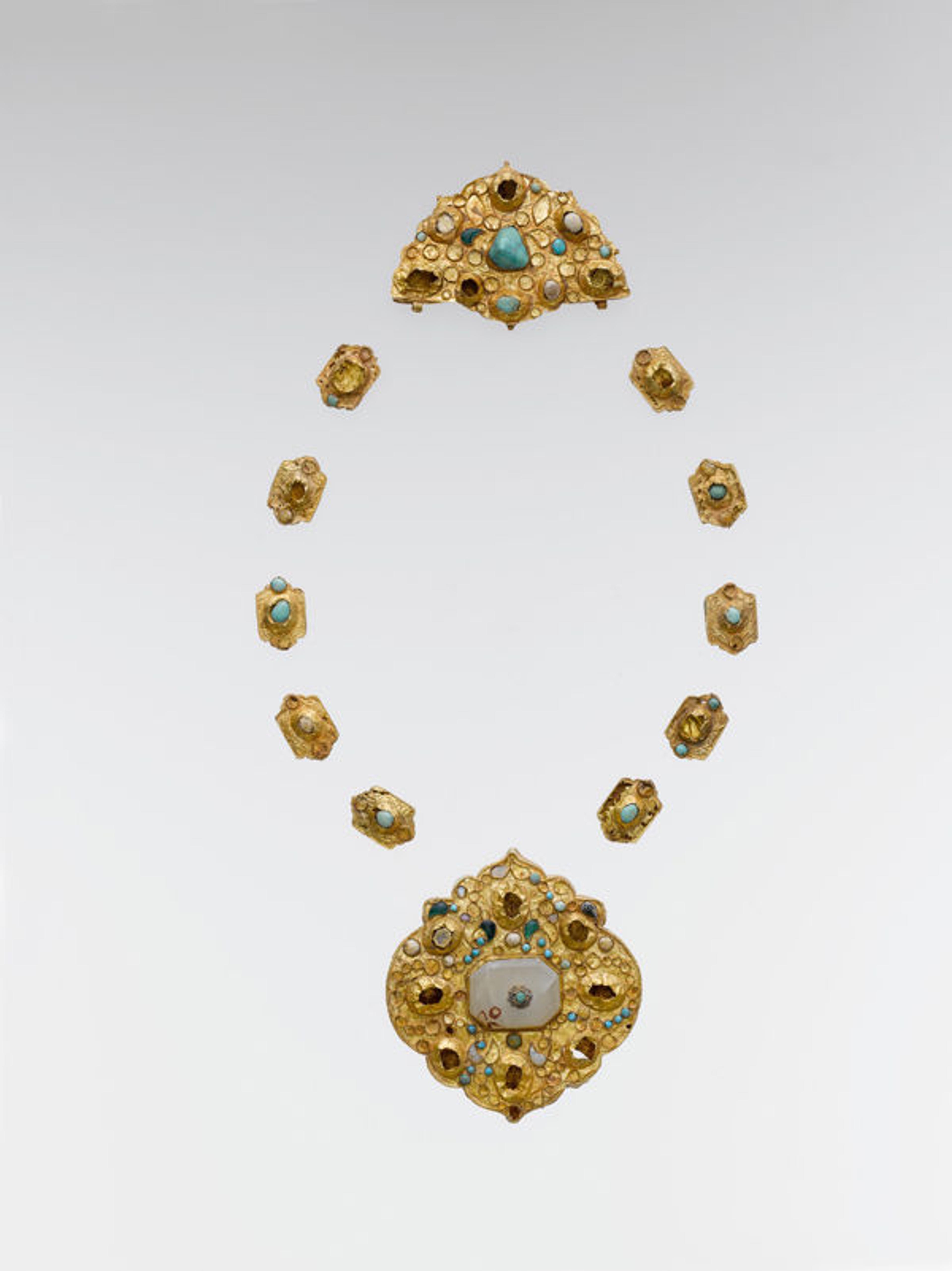 Jewelry Elements, late 14th–16th century. Iran or Central Asia, Islamic. Gold sheet; worked, chased, and set with turquoise, gray chalcedony, and glass; Large medallion: H. 2 7/8 in. (7.3 cm) W. 2 3/4 in. (7 cm) Half medallion: H. 1 3/4 in. (4.4 cm) W. 2 3/4 in. (7 cm) Cartouches: H. 3/4 in. (1.9 cm) W. 1/2 in. (1.3 cm). The Metropolitan Museum of Art, New York, Purchase, Rogers Fund and Habib Anavian Gift, 1989 (1989.87a–l)