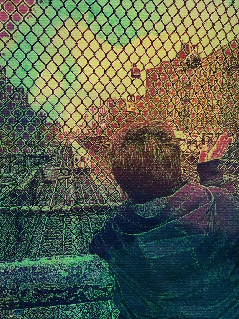 Person looking at the street through a fence