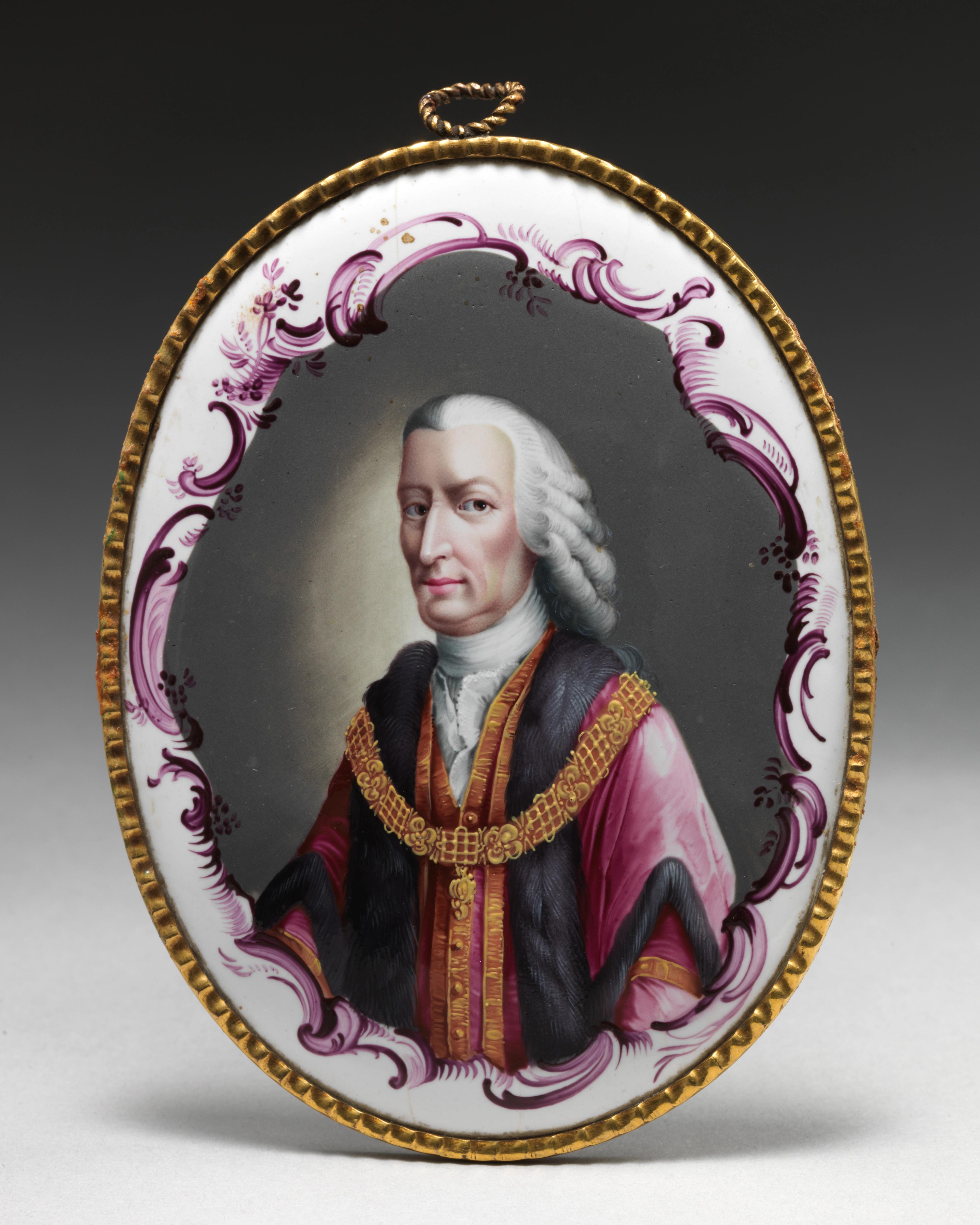 Ovular portrait of a man with gray curls, wearing pink robes with gold and fur trim.