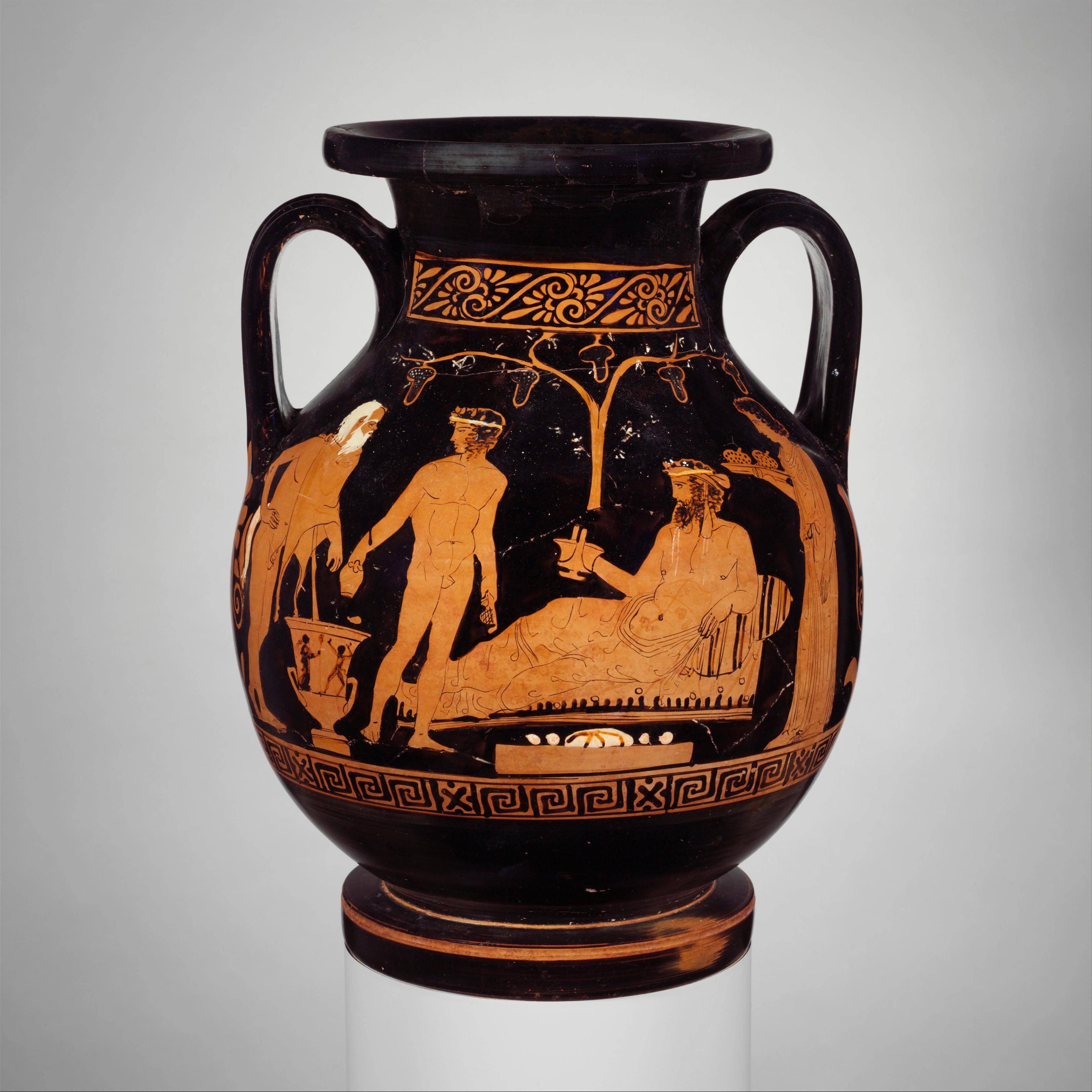 Ancient Greek vase showing a reclining man holding a cup, attended by standing figures beneath a vine.