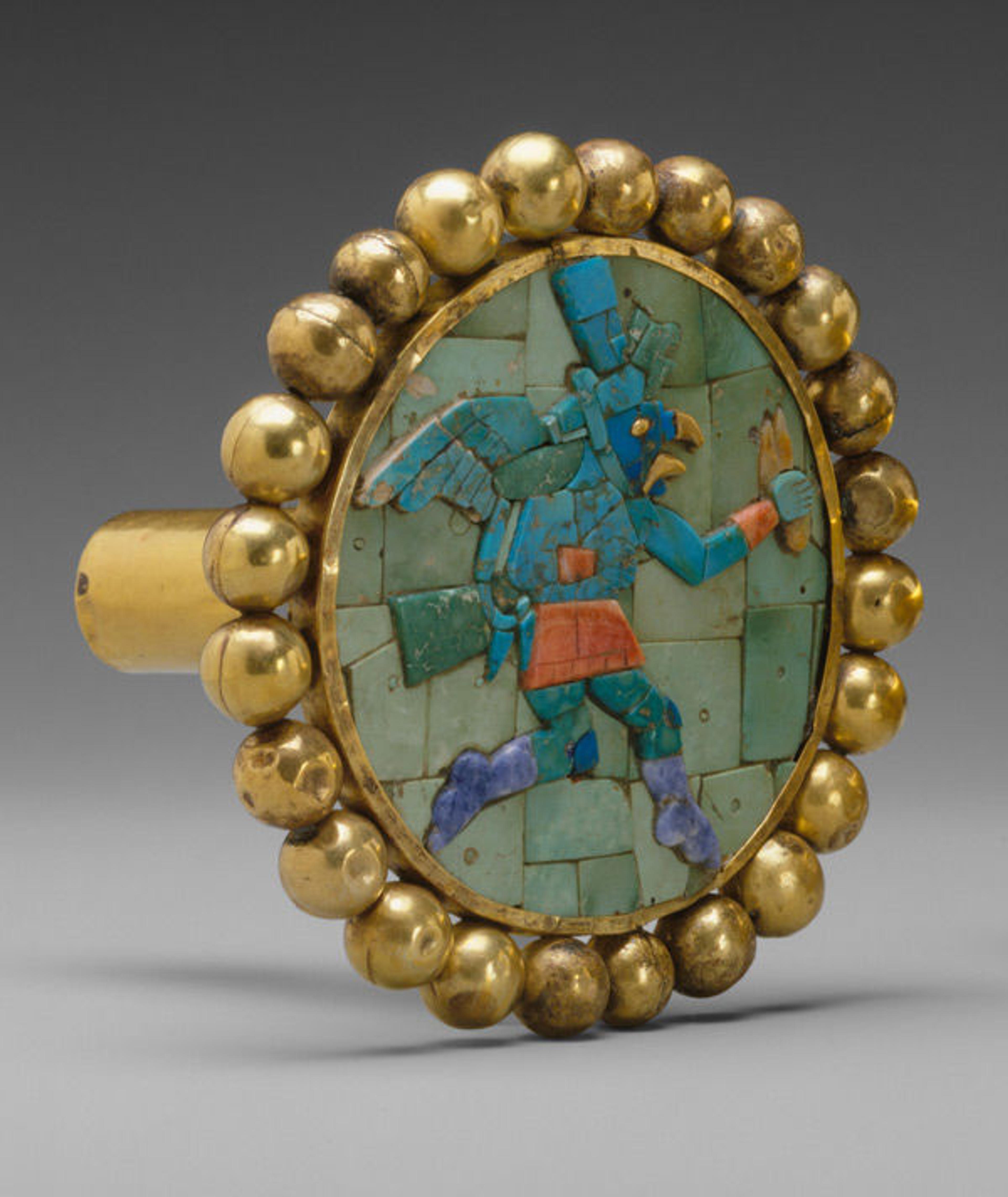 One earflare from a pair. Pair of Earflares, Winged Messengers, 3rd–7th century. Peru, Moche. Gold, turquoise, sodalite, shell; Diam. 3 3/16 in. (8 cm). The Metropolitan Museum of Art, New York, Gift and Bequest of Alice K. Bache, 1966, 1977 (66.196.40-.41)