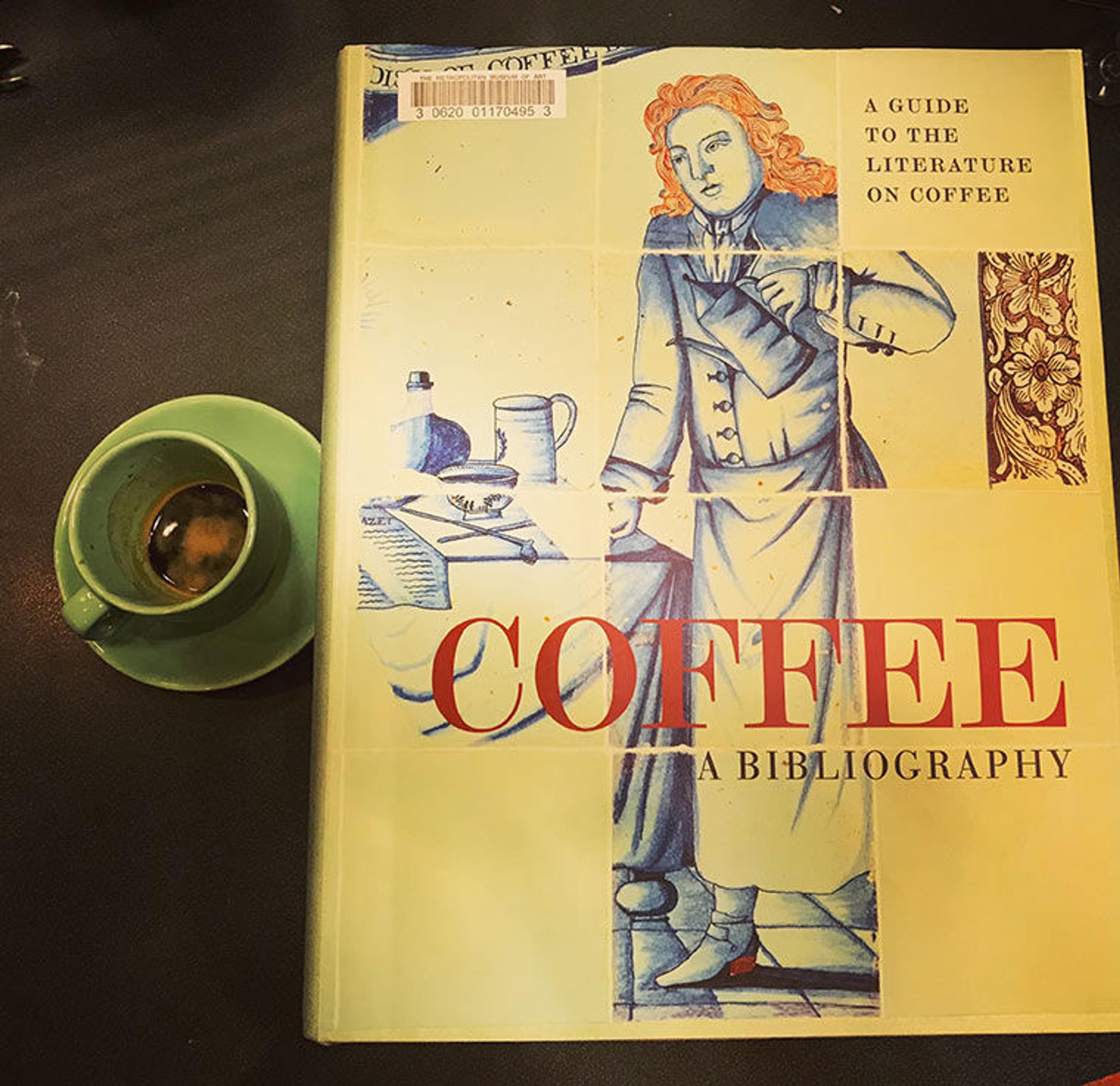 Book next to a cup of espresso