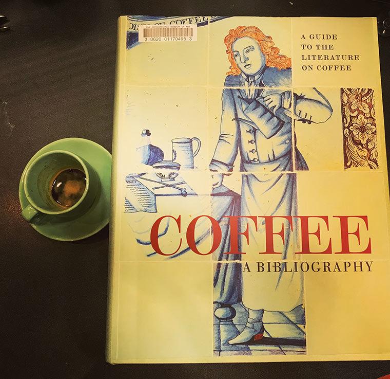 Book next to a cup of espresso