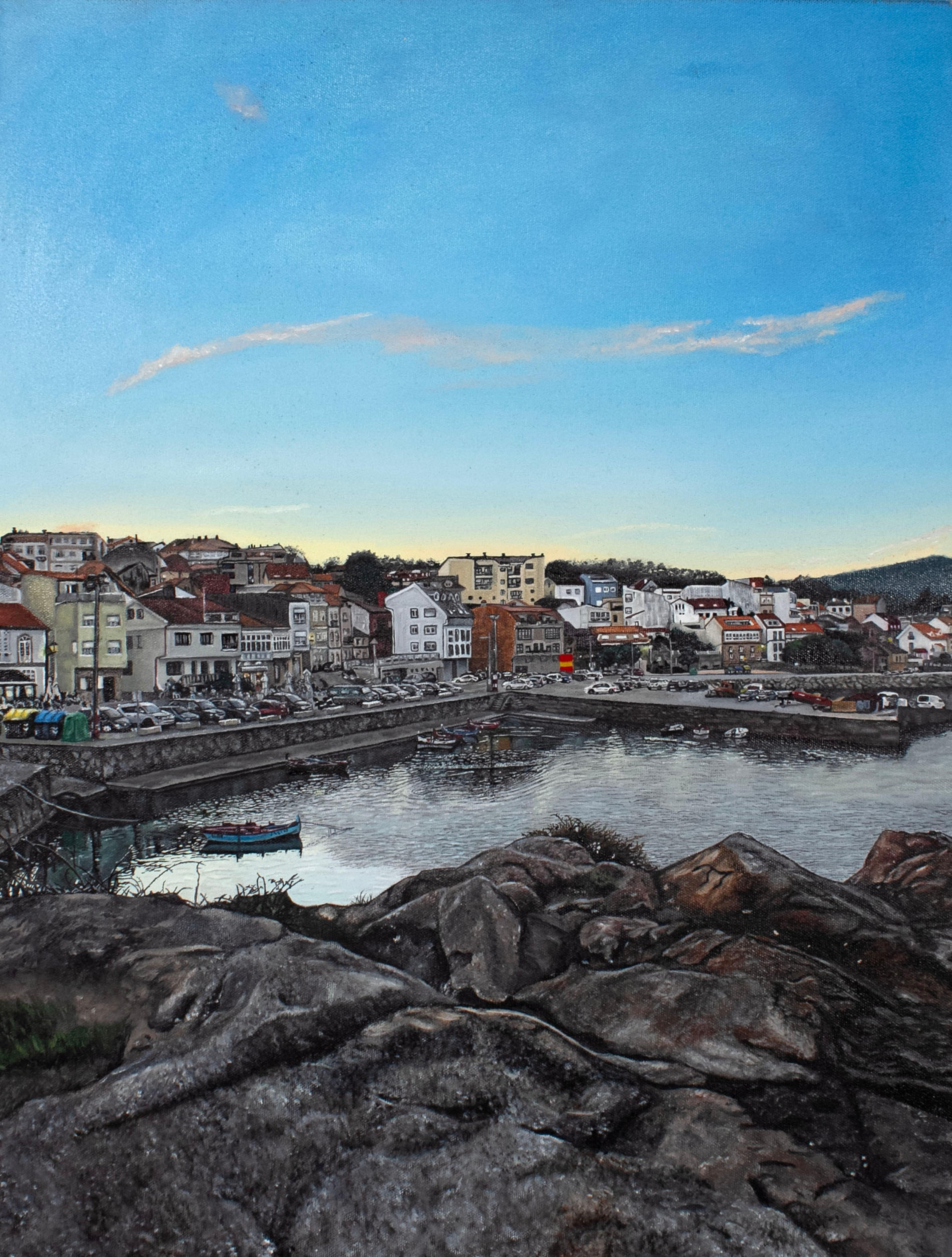Oil-on-canvas painting of the shore and harbor of Palmeira, Spain. Gray rocks and soil are shown in the bottom foreground. Behind the rocks are the gray waters of the harbor, with a few small sailboats moored to the docks in the rear. Behind the docks, rows of white and beige buildings recede into the distance behind a long row of parked cars and vendor stalls. A faint range of short hills is on the horizon. The bright blue sky overhead takes up the top half of the painting.