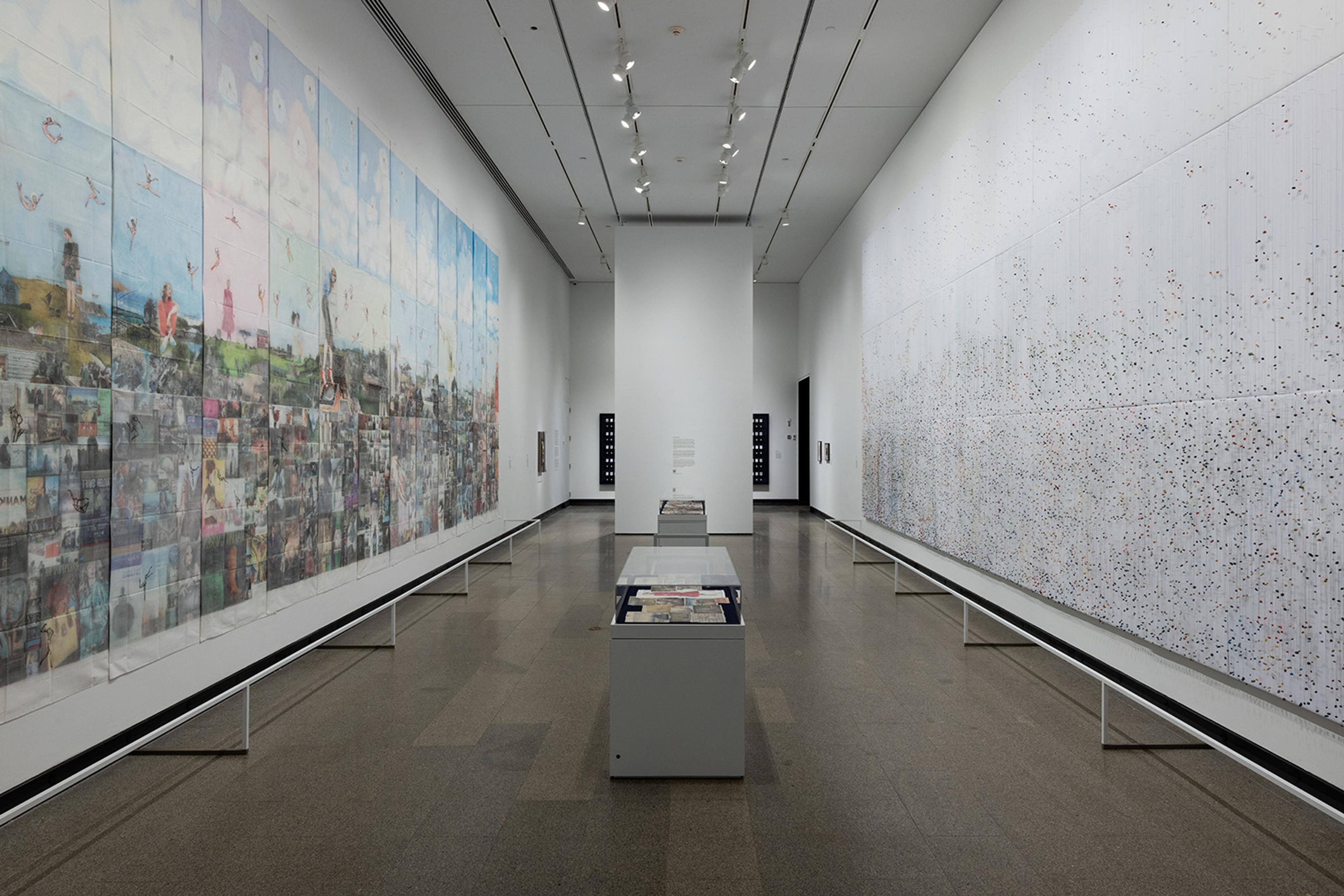 A spacious art gallery features two large murals on opposite walls. The left mural is vibrant and detailed, while the right is more abstract and speckled.