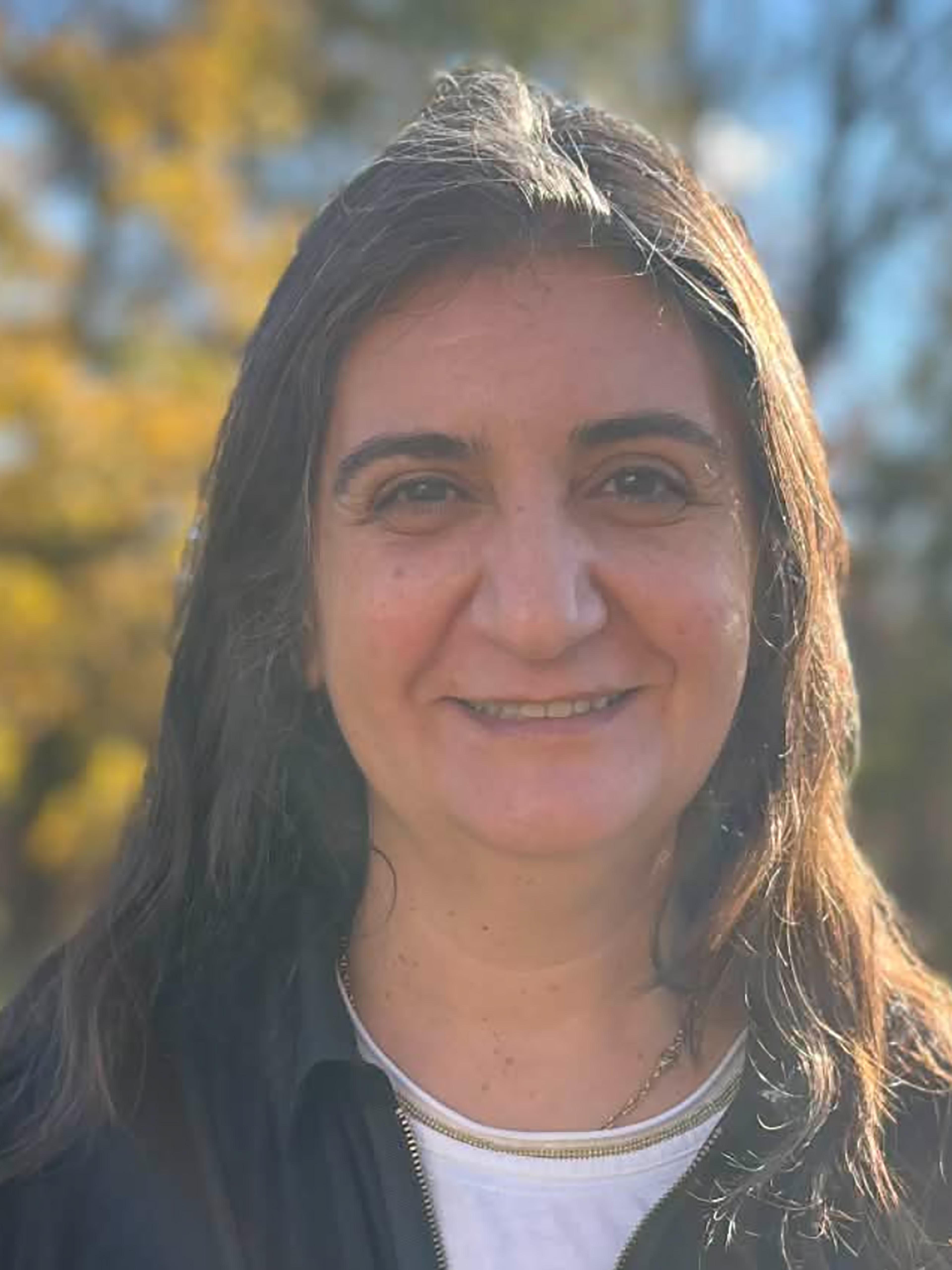 A woman with shoulder length black hair smiles