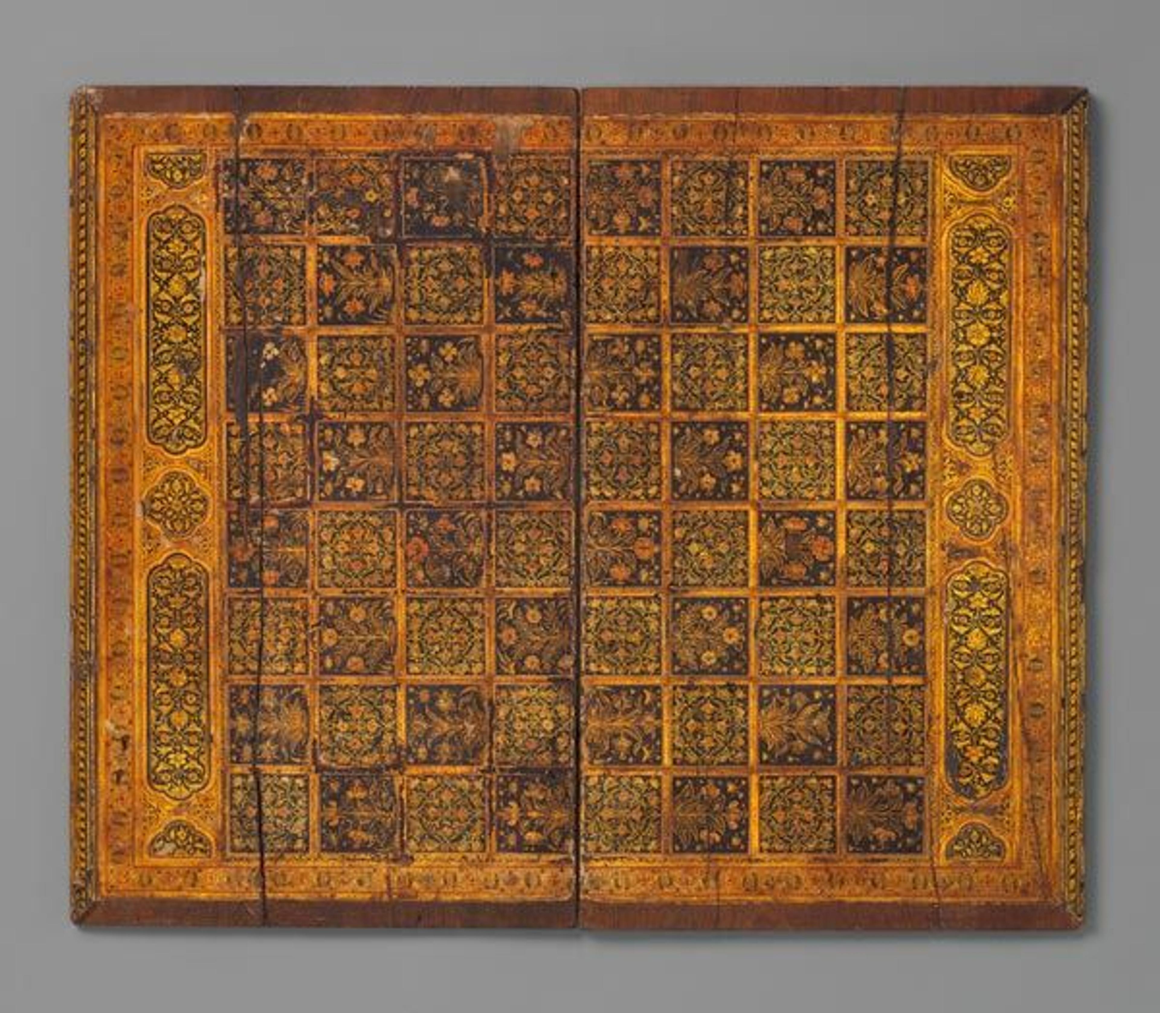 Floral gameboard, late 17th century. India. Islamic. Wood; painted, varnished and gilded; with metal hinges; H. 17 1/4 in. (43.8 cm) W. 14 3/8 in. (36.5 cm) D. 1/4 in. (0.6 cm). The Metropolitan Museum of Art, New York, Louis E. and Theresa S. Seley Purchase Fund for Islamic Art and Rogers Fund, 1983 (1983.374)