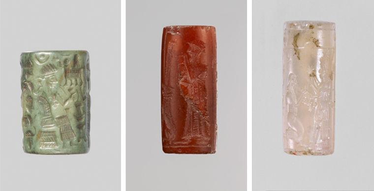 Three cylinder seals made from different stones. From left to right: one made from a green colored rock, quartzite; one made out of a red gemstone known as carnelian, and one made of a translucent pink gemstone chalcedony.
