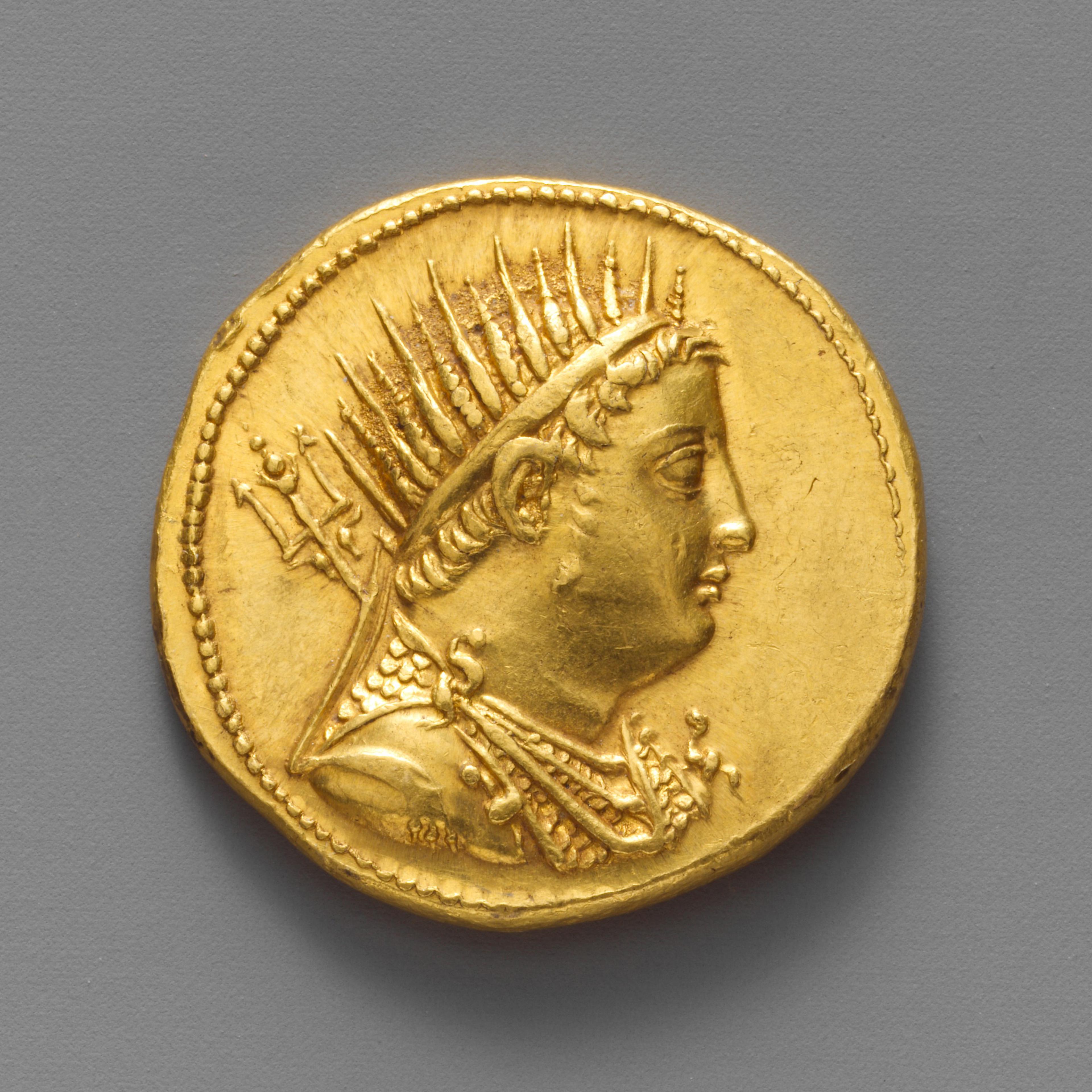 profile of man wearing a spiked headpiece on a gold coin