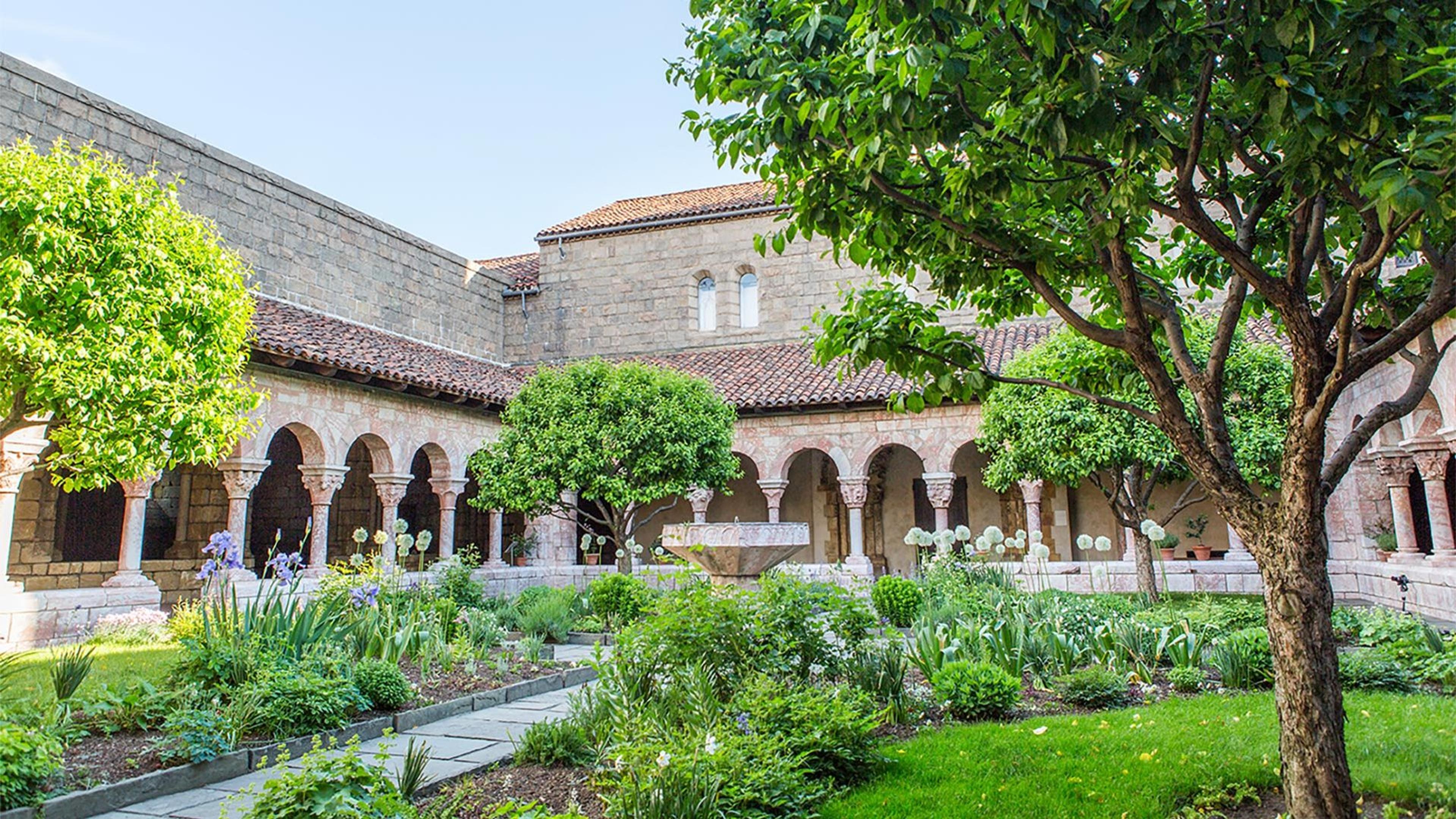 A series of archways surrounds a medieval garden