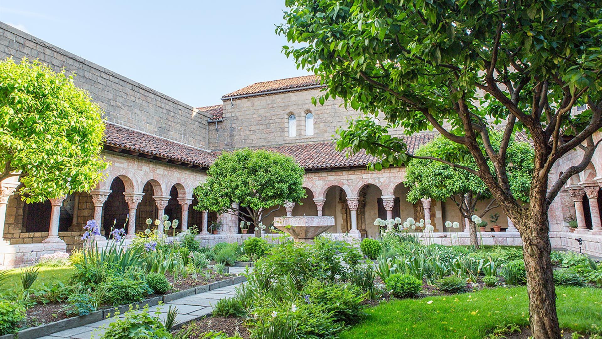 A series of archways surrounds a medieval garden