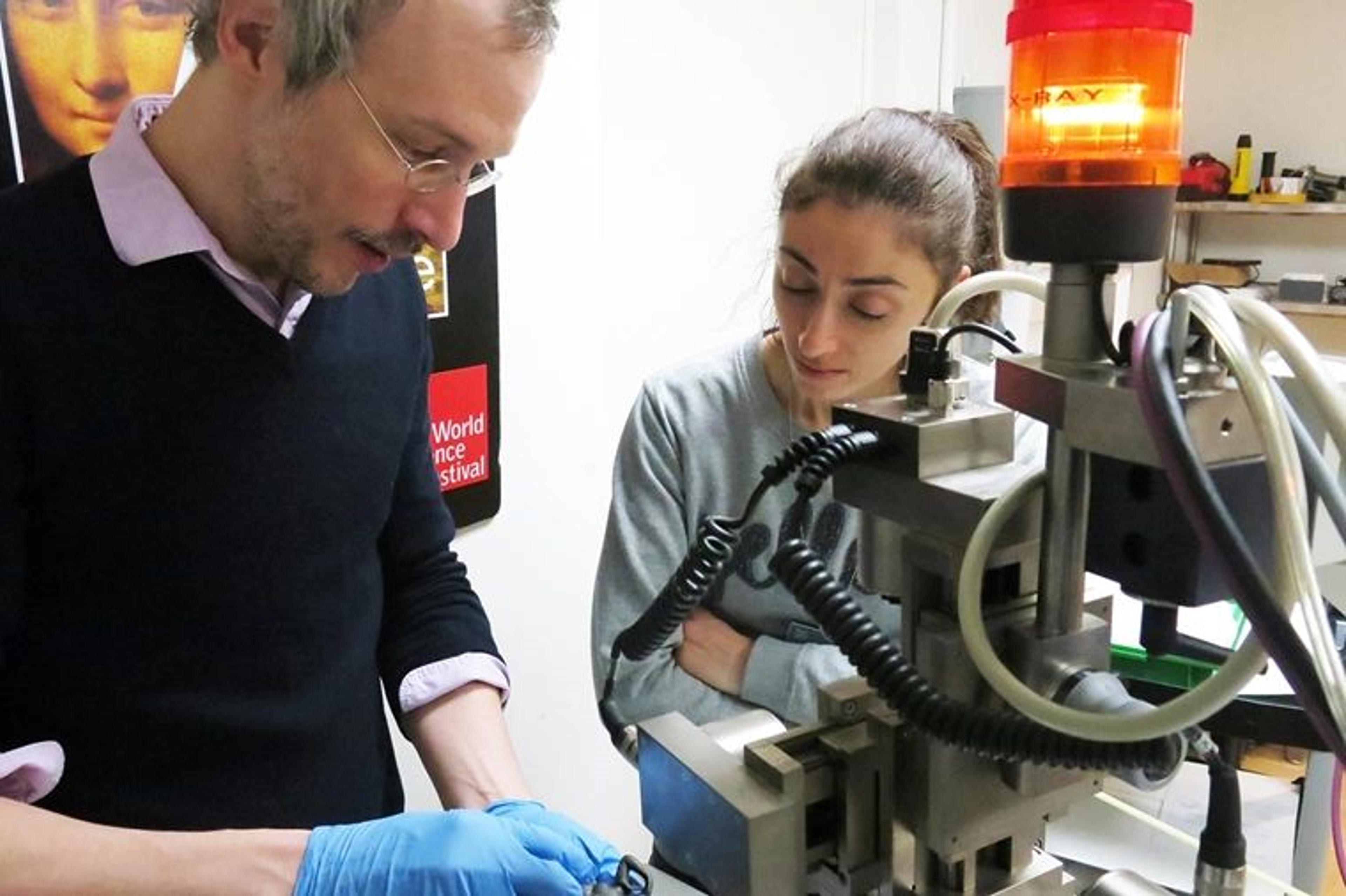 Close-up view of a man and a woman at a large machine