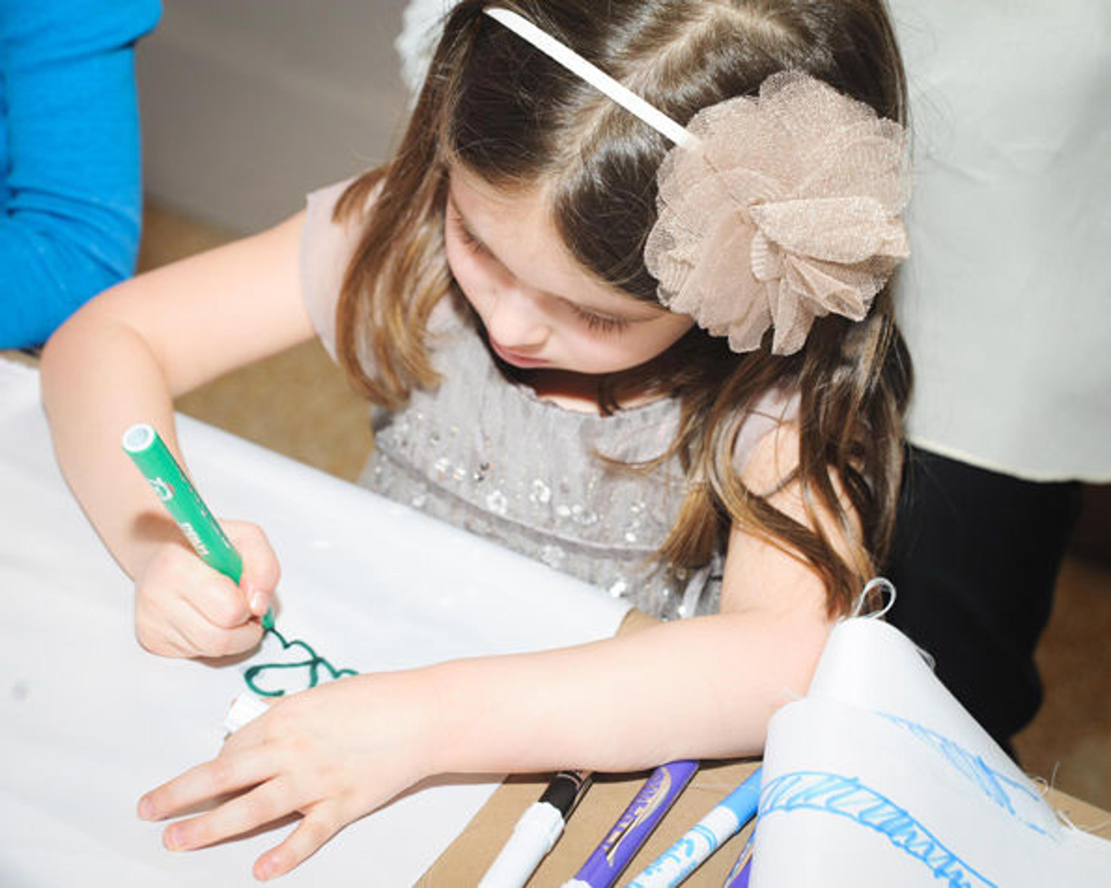 Young guest designing her own heroic banner