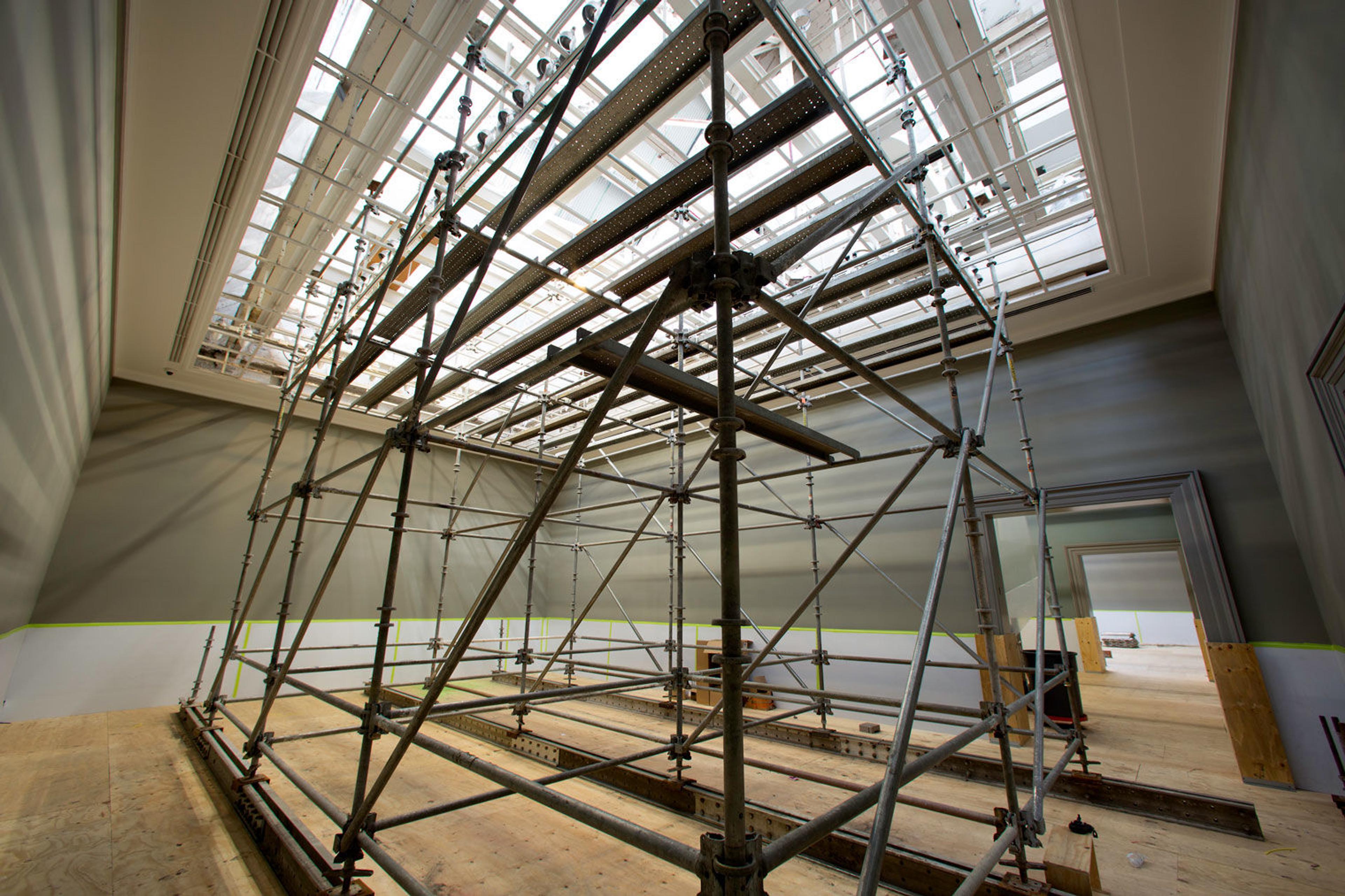 View of an empty gallery in The Met with exposed skylights in the ceiling