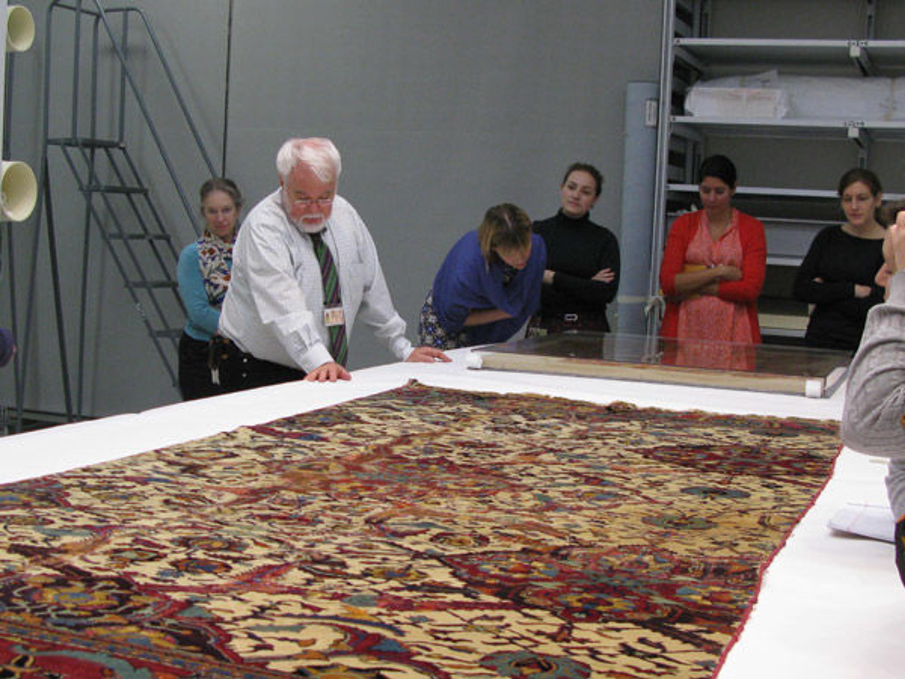 Professor Denny views Islamic carpets with Met staff