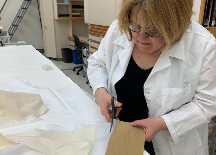 A woman creating PPE materials out of textiles at the Met.