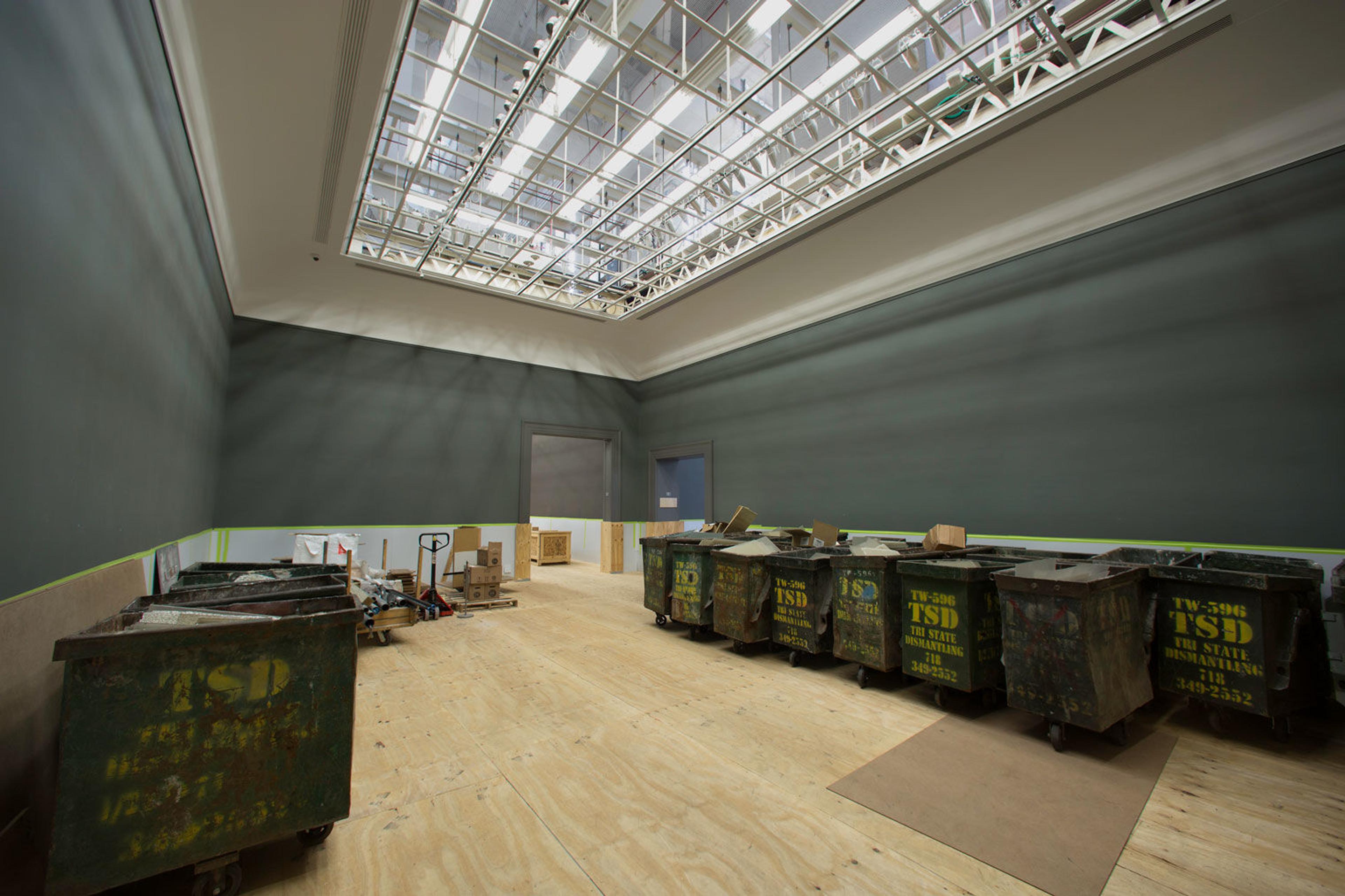 View of an empty gallery in The Met with exposed skylights in the ceiling
