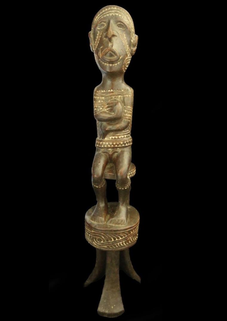 Poster featuring a carved freestanding statue of a male figure.