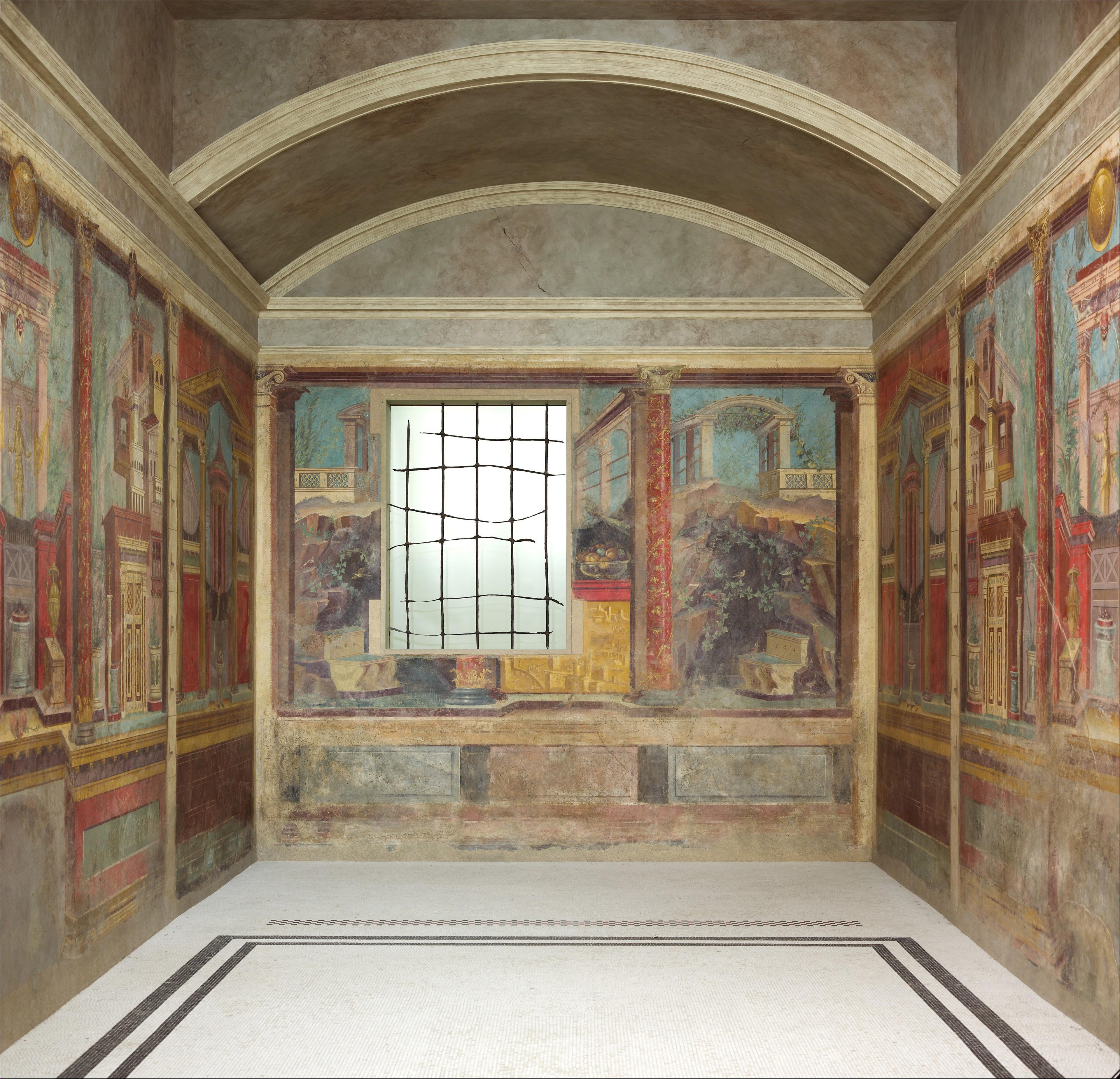 A room of the Villa of P. Fannius Synistor at Boscoreale with frescoes painted on every wall depicting architectural scenes, columns, and courtyards.
