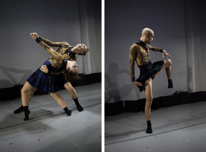 A group of modern dancers perform in front of a gray gallery wall