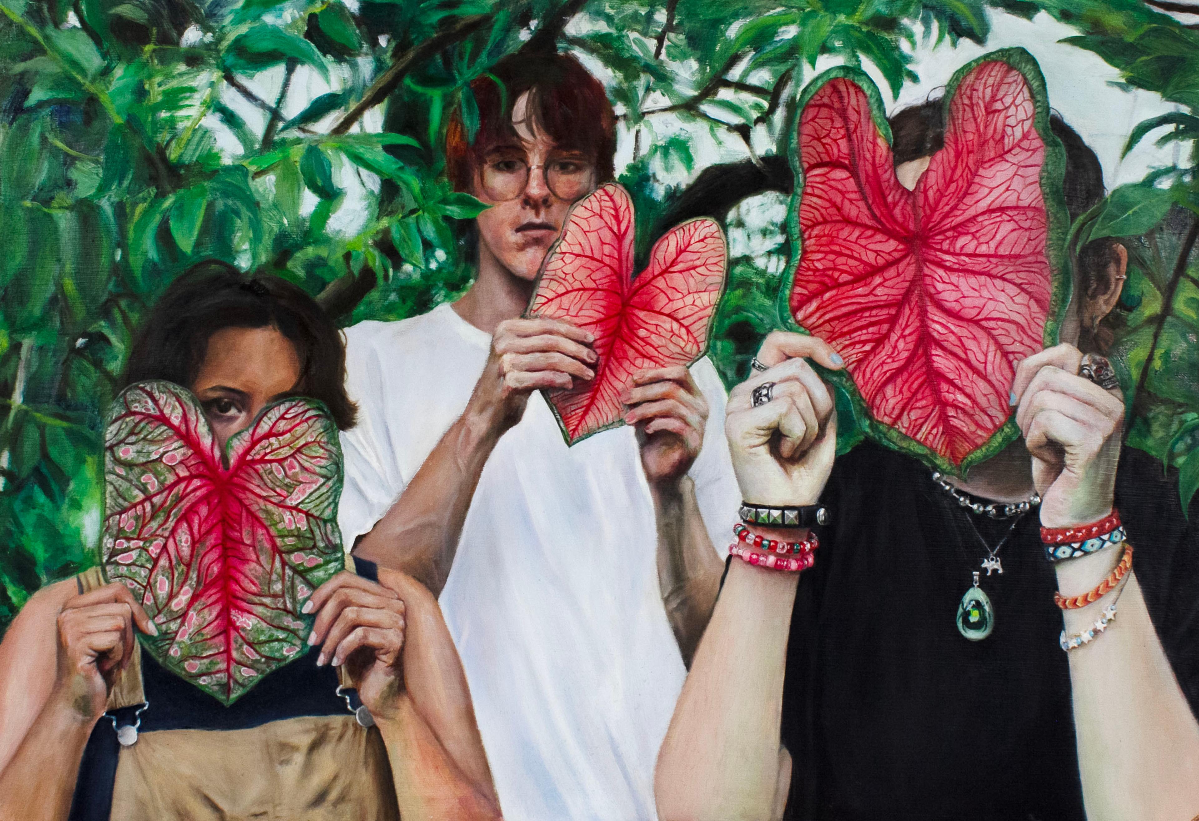 Oil painting of three people standing side by side in a clearing of lush green foliage. A short young woman in beige overalls stands to the left, a tall young man in a white T-shirt stands in the center, and a third person in a black T-shirt stands to the right. Each person holds in both hands a large, vibrant caladium leaf with a green edge and red, veiny center. The woman at left holds the leaf over her face, with only her right eye and dark hair visible. The man at center holds the leaf slightly to the left of his face, which is almost completely visible. He has short, dark hair with bangs and wears round glasses. The person at right holds the leaf directly over their face, completely hiding their features.