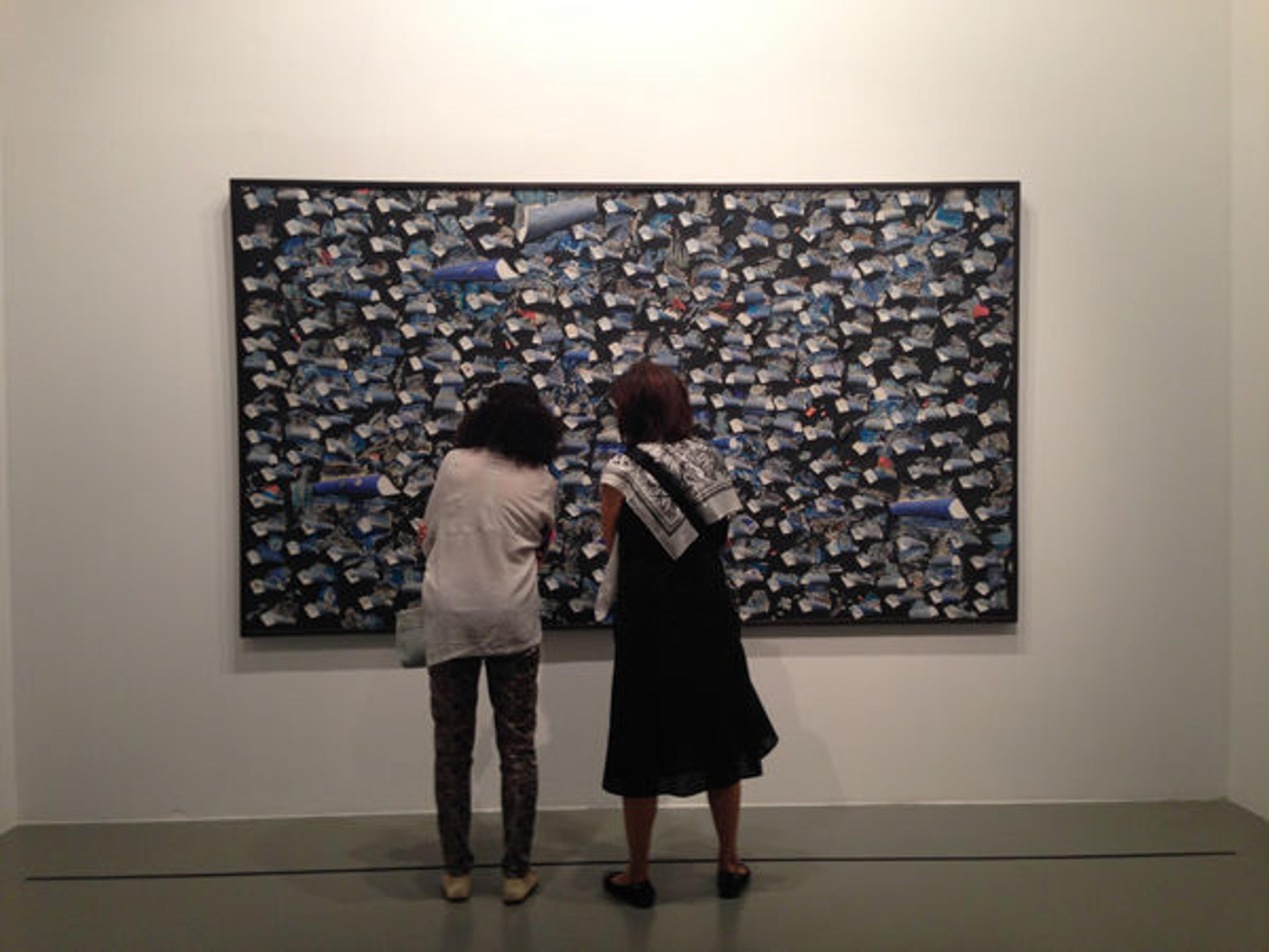 Visitors in front of "Symphony in Blue" by Burhan Doğançay