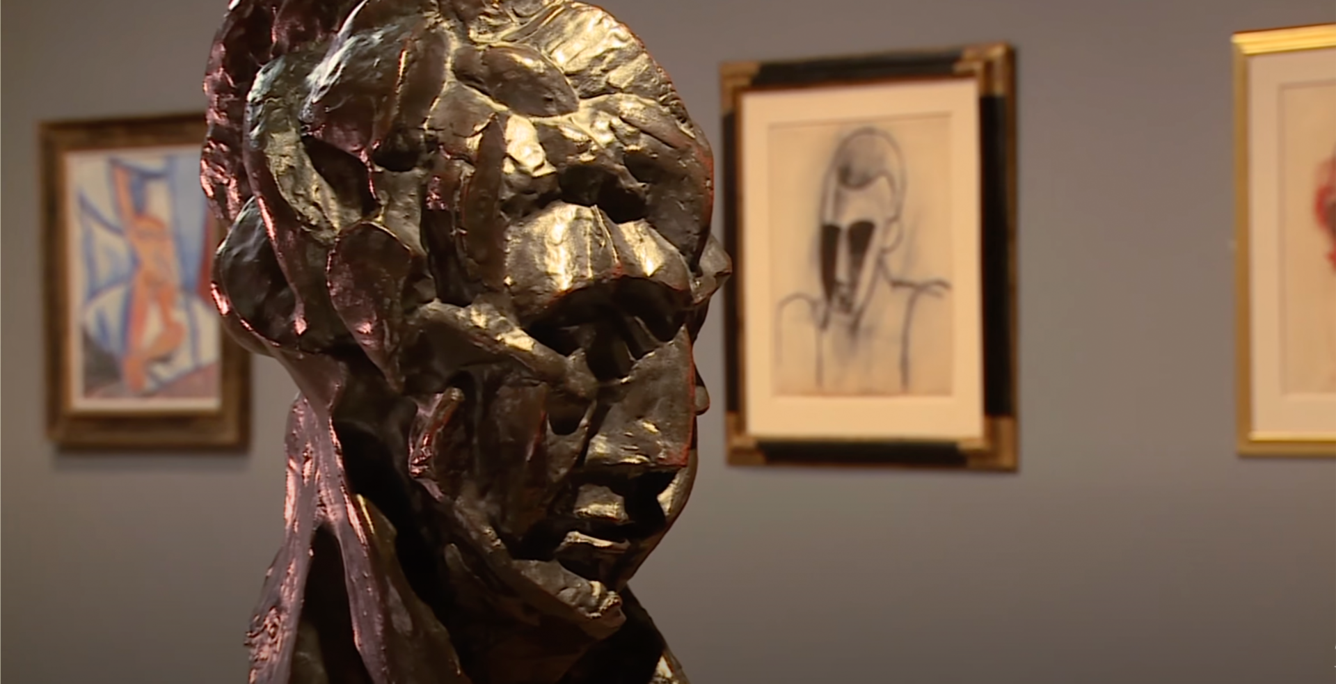 Pablo Picasso's sculpture Head of a Woman (Fernande) with Picasso's Head of a Man and Nude with Raised Arm and Drapery behind it.