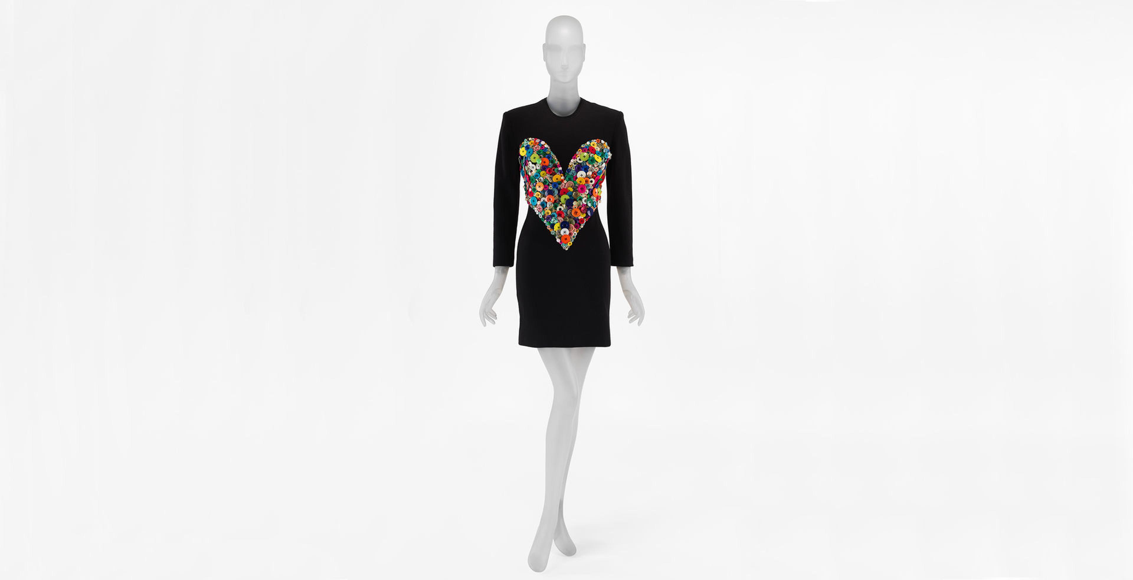 Black dress by Patrick Kelly with a large collection of colorful buttons in the shape of a heart on the bodice