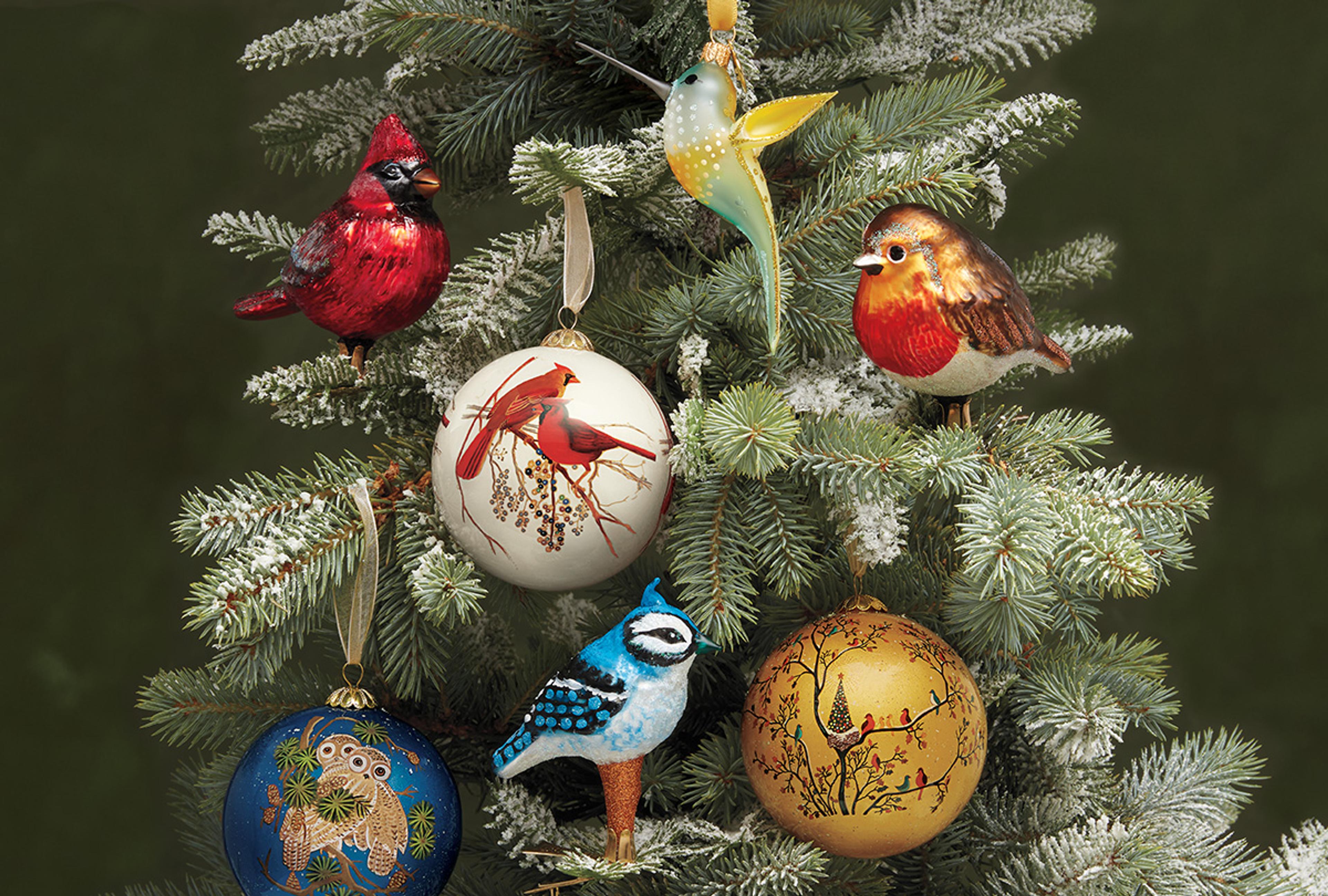 Festive bird-themed ornaments styled on a Christmas Tree.