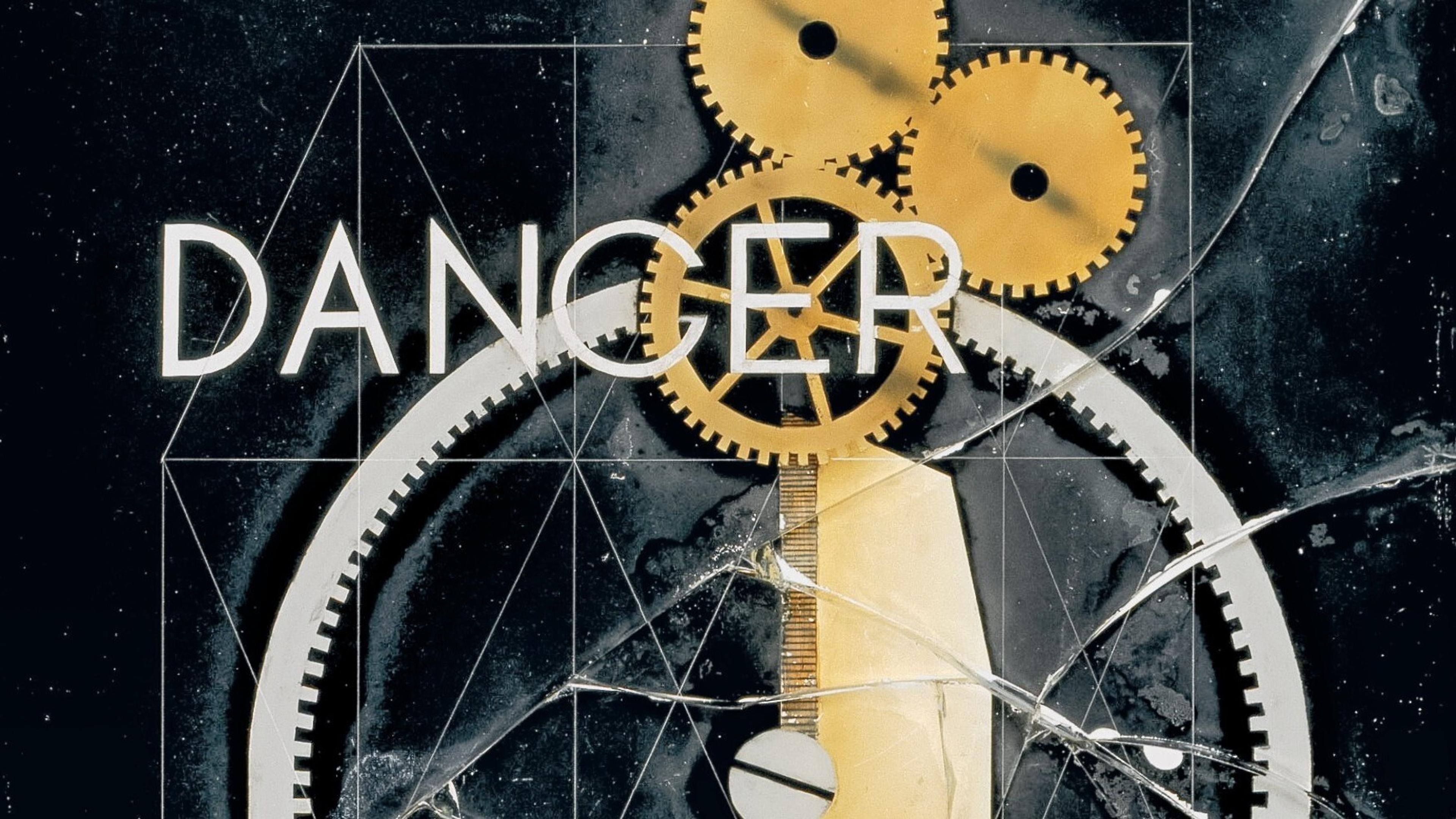 Three interlocking golden round gears, a clock-like mechanism, shattered glass, geometric lines, and with a printed work that can be read as "DANCER” or "DANGER" with a black background.